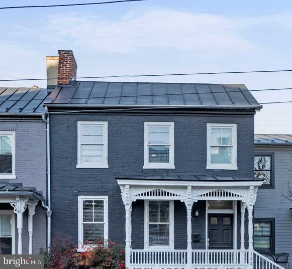 Completely renovated historical charmer in ideal city location, walkable to downtown shopping and restaurants.  The classic front porch and exposed brick exterior welcome you into the light-filled, open concept living/dining room. The entire unit has restored, original hardwoods and  two gorgeous fireplaces in the main level and master that have been restored for decorative purposes. The great room opens directly into the modern kitchen, complete with stainless appliances, granite counters and 42" upper cabinets. Upstairs, the restored hardwoods continue into the bedroom suite with  sleek private bath and private laundry.  This unit has a designated off street parking spot with additional undesignated spots located in the front.