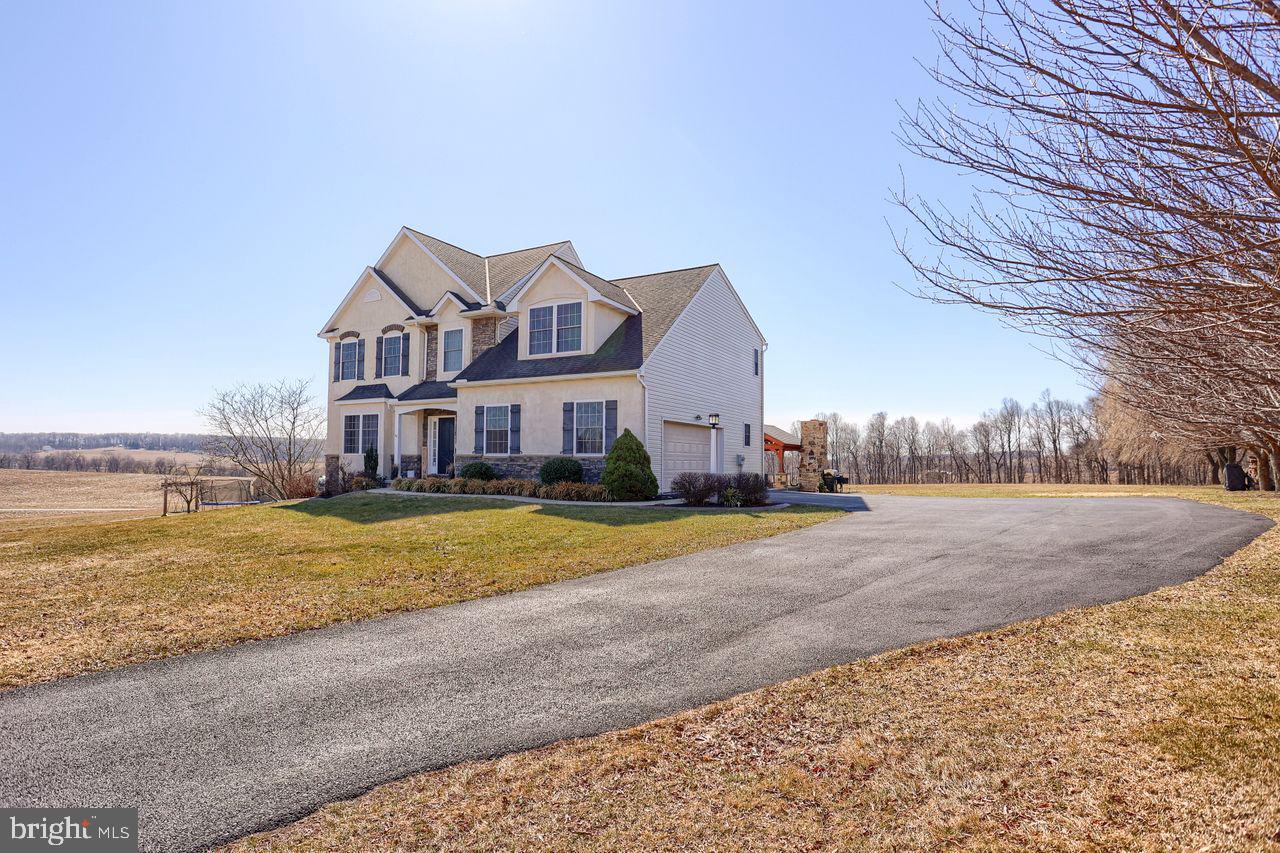 Upscale country living only 15 minutes to the highway! This charming four-bedroom, three-bathroom home sits on approximately 1.1 acres of land, offering an ideal amount of space and tranquility. The approximately 4,297 square foot interior features an expansive layout with ample natural light throughout, highlighted by vaulted ceilings and hardwood floors. The spacious primary bedroom boasts a large walk-in closet and en-suite bathroom, creating a private retreat. The gourmet kitchen is equipped with ample cabinet and counter space, complemented by a walk-in pantry for added storage. The home's rustic charm is enhanced by the charming stone fireplace in the living area, perfect for cozy gatherings. Stepping outside, the expansive lawn and covered patio provide abundant opportunities for outdoor living and entertainment, with the scenic countryside views adding to the serene ambiance. The sellers built a spacious and beautiful outdoor living room for you to enjoy with a wood-burning fireplace, pergola, ceiling fan, and hot tub. Additional features include a tankless water heater, Nest thermostat, and a new garage door opener with camera, ensuring both comfort and convenience. This stately home is ideally situated, with a quick commute to both Hunt Valley and York, making it an ideal retreat.