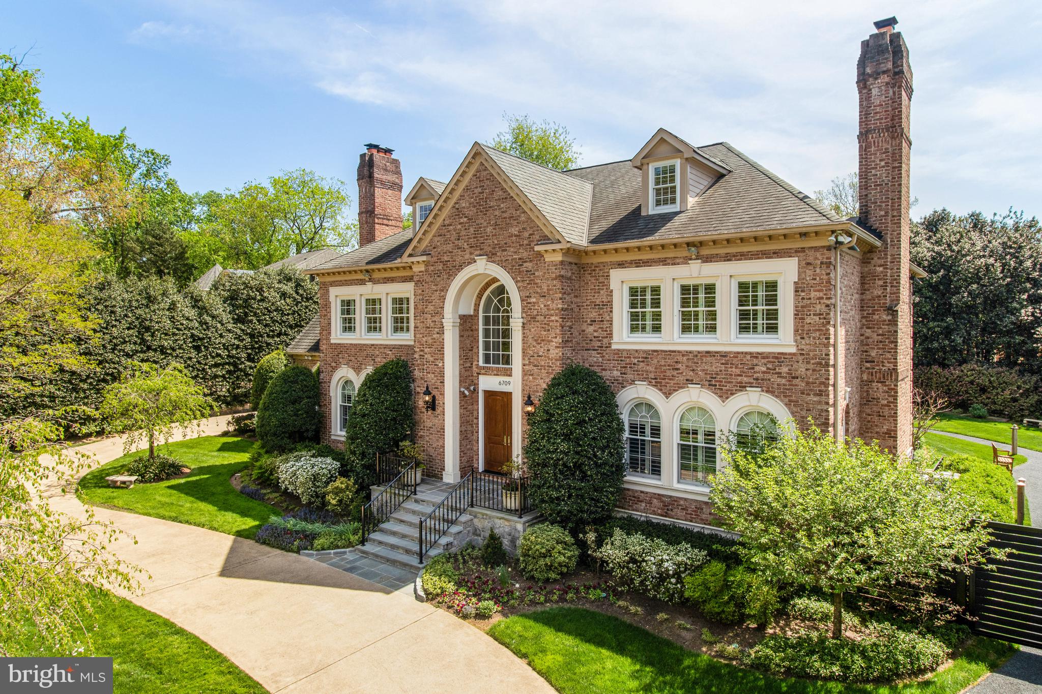 Introducing a spectacular 8 bedroom, 10 full and 2 half bath, all-brick custom-quality home situated on a lush, professionally landscaped private .5-acre lot in sought-after Langley Forest.  This extensively upgraded and meticulously maintained property offers luxury living in a private and serene setting and includes over 9,300 finished sq ft on 4 levels.   

The thoughtfully designed floor plan provides ample space for comfortable living and entertaining. Entering into the grand two-story marble foyer, with curved imperial staircase, the main level features formal living and dining rooms, each with a wood-burning fireplace, a sun-filled library with floor-to-ceiling custom built-ins and a spacious family room with a stone fireplace and wet bar and elevator access to the upper and lower floors. The intelligently reimagined BOWA kitchen is a focal point of the home, with Poggenpohl custom cabinetry, a large center island with seating for 5, Wolf 36” range and wall ovens, Sub-zero full-size refrigerator and freezer, Miele dishwashers, pot-filler, hot/cold filtered water and under-cabinet lighting. 

The spacious upper level of the home offers ultimate privacy among the four ensuite bedrooms. The luxurious primary suite is connected to a large sitting room with fireplace, with separate, his-and-hers walk-in closets, as well as his-and-hers bathrooms. A back hall leads to another private bedroom and across the upper landing, there is a 2-bedroom suite, with 2 full baths and a shared sitting area. There is an additional 4th level with 2 two ensuite bedrooms and wrap-around attic space. 

The lower level of the home offers ultimate flexibility with a recreation room with a fireplace, a kitchenette, and two additional ensuite bedrooms, which could also be used as a home-gym/yoga studio, craft room or home office. A back hall leads to the laundry room with three sets of new stackable W/Ds, two additional rooms and full bath, ideal for an au pair suite! 

A large slate patio, surrounded by mature landscaping and beautiful grassy area, offers luxurious privacy, accessed by the kitchen, family room and library. This space is perfect for outdoor entertaining, gardening, or simply enjoying the serenity.

Notable features include an elevator that services the three main levels, inlaid hardwood floors, plantation shutters throughout the home, a whole-house generator, central vacuum, intercom, robust security system and Anderson windows and doors, replaced in 2022. The 3-car side-load garage offers additional storage in a fully conditioned space. 

This exceptional home offers unparalleled luxury, privacy, and convenience in a highly desirable location. Located in the Langley High School pyramid, near Tysons Corner, downtown Washington, Dulles Airport, and major commuter routes.