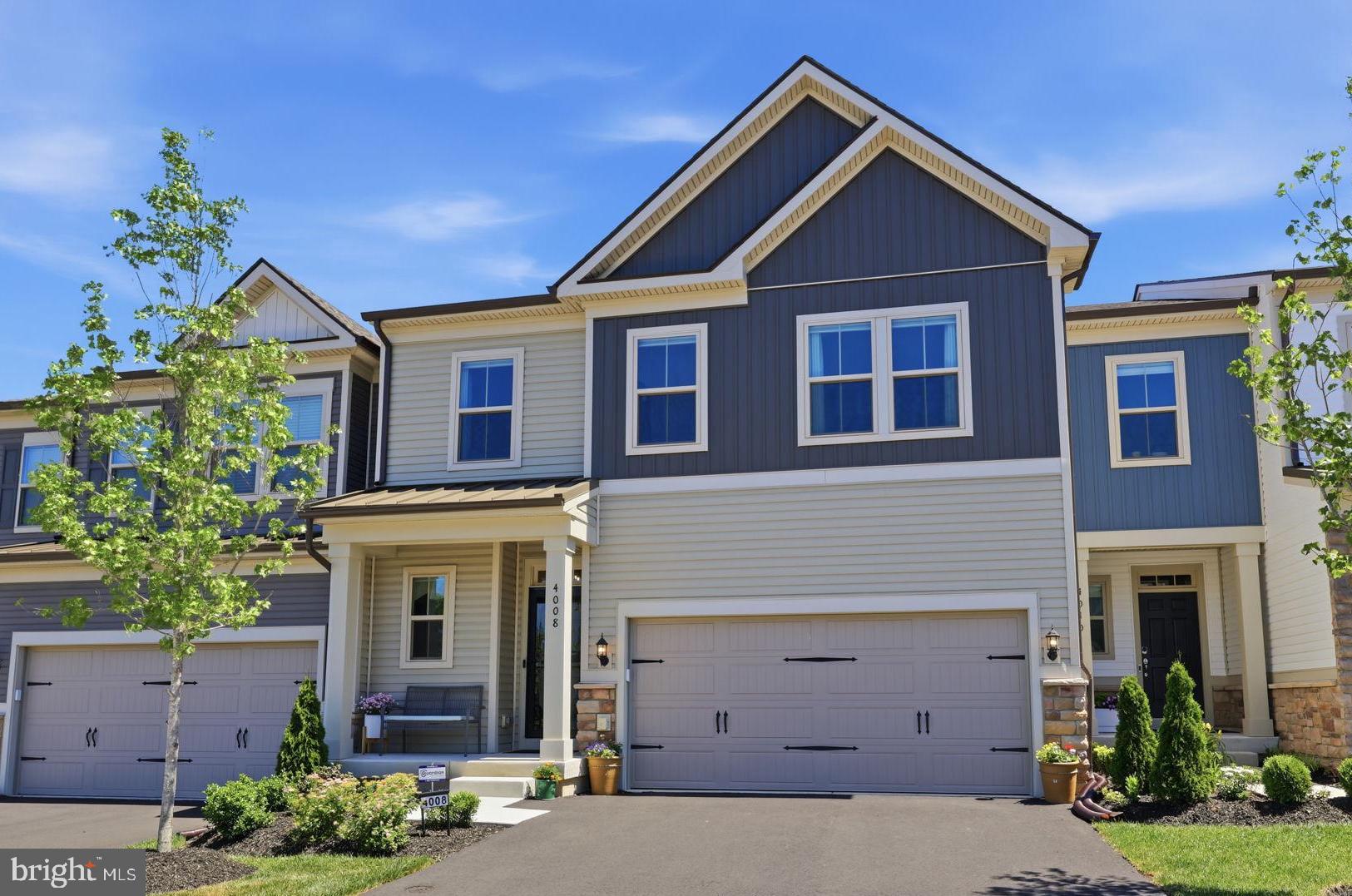 NEWER CONSTRUCTION WITHOUT THE WAIT - PREMIER TOWNHOME WITH EASY MAINTENANCE AND FLEXIBLE LIVING! Welcome to 4008 Marquis Lane in Jamison, PA, an expansive luxury townhome with 3 Bedrooms and 3.5 Bathrooms in the award-winning Central Bucks School District. This home perfectly combines a “lock and leave” lifestyle with a beautifully spacious floor plan that is ideal for downsizers, multi-generational families, hosting guests, or versatile everyday living. Upon entering, the two-story Foyer showcases high-end vinyl plank flooring that runs throughout the entry level, stairs, and upper hallways, with a convenient Powder room and hall closet located just off the entry. The Foyer opens directly into an incredible open floor plan featuring a chef’s dream gourmet Kitchen showcasing a generous center island, Quartz countertops, abundant cabinetry, and deluxe ZLINE stainless appliances. From the Kitchen, the layout flows effortlessly into a Dining Room accented with wood paneling and a grand two-story Living Room anchored by a shiplap electric fireplace perfect for relaxing at home or entertaining guests. The sliding glass doors reveal a private deck with built-in shades and stairs to access the open space behind the townhome, overlooking a serene walking path. Tucked away on this main level is the Primary Suite, a peaceful sanctuary featuring a sun-filled Bedroom, walk-in closet, and a spa-inspired ensuite Bath complete with a glass shower with bench, dual vanities, a secluded water closet, and a linen closet. Completing this floor is a highly functional mudroom and laundry room featuring functional built-ins and a bench, and connects to a freshly painted and epoxied two-car garage with an EV charger. Upstairs, a thoughtfully designed layout highlights two large bedrooms, each with their own full bathrooms, providing the flexibility of a second primary suite. This level also offers a spacious loft, a media room ideal for movie or game nights, and a bonus room for a home office or flex space. Additional highlights throughout the residence include custom trim, wainscoting, distinctive accent walls, upgraded lighting, ceiling fans with extra mounting locations, and a front storm door. Downstairs, a massive, full basement offers endless future potential, while transferable warranties covering mechanical systems, water infiltration, and structural components provide added peace of mind. This wonderful, highly sought-after community includes a sparkling outdoor pool, playground, fire pits, and trail paths for your enjoyment. Located a short drive from Doylestown, New Hope, and major roadways while also commutable to both Philadelphia and New York City, this home delivers modern luxury, thoughtful design, and a vibrant community lifestyle, all without the delays of new construction, making it an opportunity you won’t want to miss.