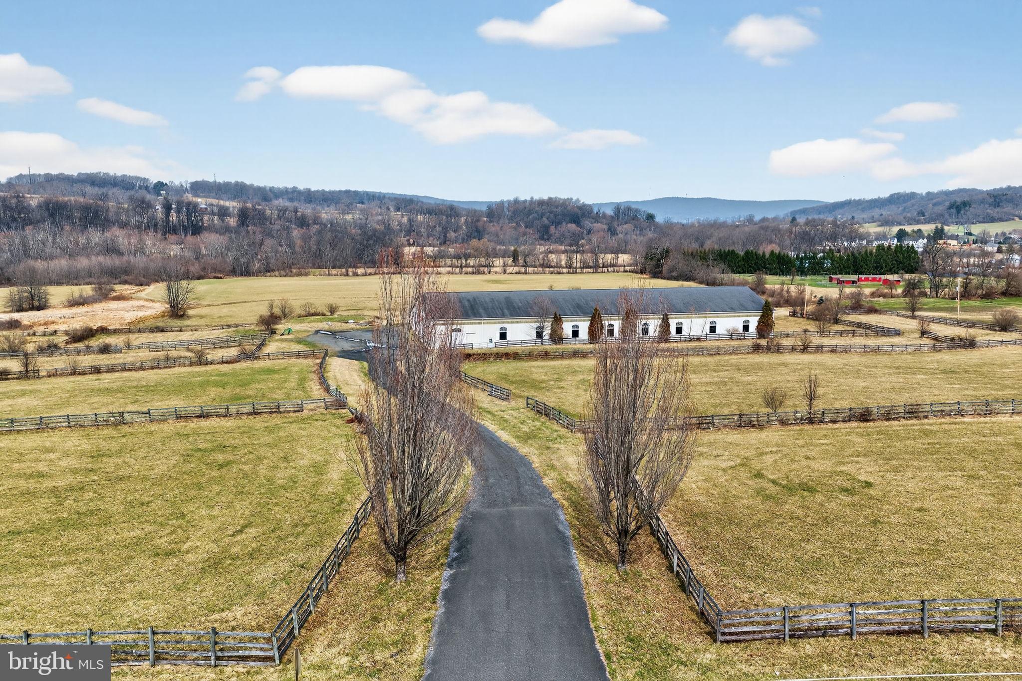 Welcome to Saucon Creek Farm! If you have dreamed of owning a premier horse farm in the Lehigh Valley, this is your chance! This equestrian facility offers a fantastic opportunity for professional use, a private estate, or potential residential subdivision. Located in Southern Lehigh School district, near The Ridings at Saucon Creek, the property provides quick access to Route 309, I-78 and the PA Turnpike; and is just minutes to the Promenade Saucon Valley. Enjoying level topography and rolling pastures, this facility is an equestrian lover’s dream! * * Features: · Main Barn: 18’+ ceilings and 23 (12’x12’) Southern Yellow Pine stalls; removable partitions allow for oversized stalls- the layout permits additional stall expansion. · Electric to all stalls · Indoor Arena: 80’x200’ with Perma-flex rubber footing over angular sand; includes an upper-level viewing area. · Also includes: 16’x24’ Office/Feed room, 12’x24’ Storage Room, and a dedicated Tack Room/Lounge with viewing windows into the indoor arena. · Additional Amenities: Two wash stalls with hot water, and a full bathroom with shower; Two 24’x36’ bonus rooms (over 2,300 square feet of finished space) offer flexible space for meetings, staff, or therapy area. Two Aquacisers are negotiable. · Grounds & Outbuildings: · Outdoor Arena: 150’x250’ with blue stone and rubber footing. · Turnout: 14 pastures and 9 pens; significant acreage remains available for additional pastures or an outdoor course. · Bank Barn: 60’x36’- .Constructed with three stone walls, one metal wall, and a metal roof. · Tax records show 38 Acres; survey shows 42 Acres- Buyer to Verify · * * This expansive acreage combines high-tier training infrastructure with a prime location for commuting and accessibility, and also offers possible subdivision potential (buyer to verify with municipality). **Please do not visit property without an appointment.