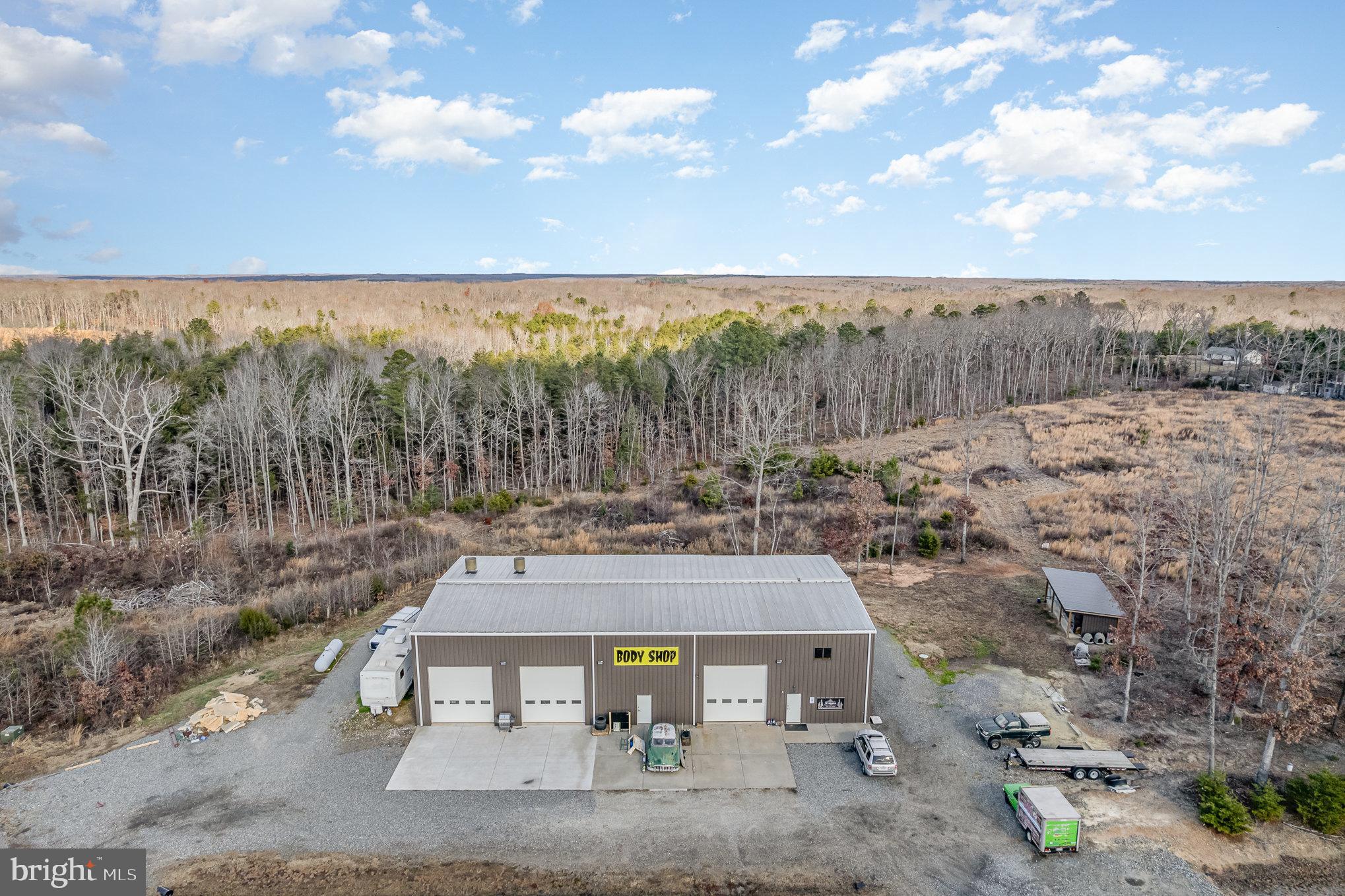 Prime Business Opportunity Close to Lake Anna and off of Rt 208 main roadway. Excellent 7500 Sq Ft Building with over 5000 Sq Ft of Warehouse/Workspace and over 1800+ Sq Ft of Office/Finished Space. This building has so much to offer! Currently used as an auto body shop, but could easily be converted into multiple businesses, warehouse use, trucking facility, office space or so much more. Reinforced concrete floors, 22 Ft Ceilings, 4 Truck Bays, Car Lift, LED Lighting, LVP and Tile Floors, Reception Area, Storage, 2 Bathrooms Including Full Owners Suite Upstairs, Multiple Offices, 400 Amp Service, 36 x 12 Pole Barn, Parking, and 1 Acre C-2 Space with Main Road Access. Less than 7 years old, this property could be used for many different business endeavors and is a great investment for a growing area close to downtown Lake Anna and minutes from the Marina.