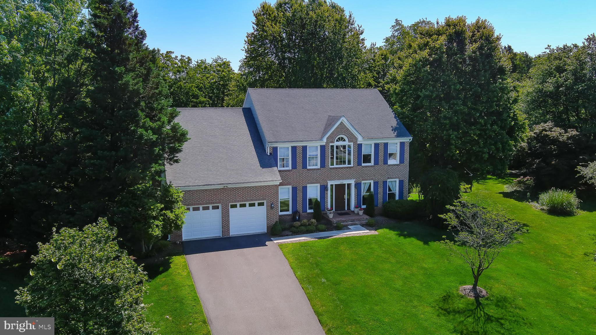 Elegant but casual interior, lots of natural light,  spacious rooms,  many beautiful updates, a screened porch, 2 stone fireplaces, and a delightful and expansive rear yard (3/4 acre) all help make this a welcoming home, practically pleasing and aesthetically satisfying!  Upgraded bluestone walkway, brick stoop, and new front door all enhance the home's curb appeal. The two-story foyer features a winding staircase and palladium window.  The main level library boasts wall-to-wall bookshelves and can be closed off from the entry with French doors,  providing the ideal home office. A powder room is off the hallway.   The gourmet kitchen features a new gas cook-top, stainless appliances, large center island and ample counter space ( granite).  You'll love the large window overlooking the herb garden.  Enjoy meals and gatherings in the  breakfast area (with built-in bookcase)  --this opens to the large family room with stone fireplace flanked by windows, and to the charming screened porch. A mudroom between the kitchen and garage offers cabinetry and a desk area.  The garage has just been fully painted - walls, ceiling and flooring.    ***  Upper level primary suite consists of the  bedroom, spacious sitting room, and luxuriously renovated bath with waterfall shower, free-standing tub, heated flooring, and beautiful vanity area. Closet is a full walk-in.  Three other bedrooms and a beautiful, modern  hall bath complete this level. 
Lower level  offers a cozy gathering place with a stone fireplace and wet bar,  a bonus /exercise room,  a large den or guest room. and huge storage area which is under the family room.  New ceramic tile flooring adds great appeal and function!  Walk-up stairwell exits to the side.  Roof is about 10 years old, HVAC 4-5. Brand new cooktop.  Irrigation system in place.  Second refrig, separate freezer will convey.  Trampoline can convey.  Quick settlement, then 60 day rent-back preferred.