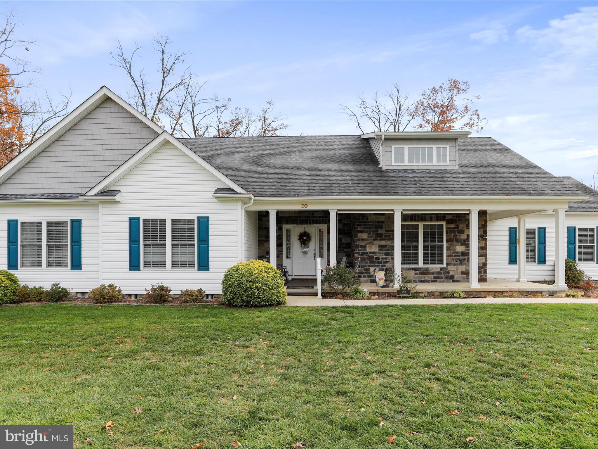 Very well-built contemporary style home on one level built by Jim Harvey and meticulously maintained by the current owner. Rock on the covered front porch or enjoy the rear deck views with the electric awning for shade. The corner lot features a storage shed and beautiful lawn. The interior has an open floor plan with gorgeous hardwood floors throughout. The living room has a cozy stone propane fireplace for those cool evenings, that flows right in to the large kitchen with pantry & plenty of cabinets & countertop space. There is a breakfast area overlooking the rear deck and a formal dining room with views of the front yard. The larger primary suite has hardwood floors, French doors that lead to the rear deck, a large walk-in closet & a spacious bathroom with tile shower, dual sink vanity and a walk-in tub feature. There are 2 additional bedrooms, another full bathroom that is access from the hall & through one of the additional bedrooms. The lower level is finished with a family room with wet bar & another full bathroom with unfinished space for storage. The 2 car attached garage has 8' garage doors & attic access for additional storage. Lakewood is a private residential lake community with over 500 acres & nearly 3 miles of lake shoreline, playgrounds, trails, beach area with pavilion & restrooms. It is just a couple of hours from Baltimore, DC & Northern Virginia.