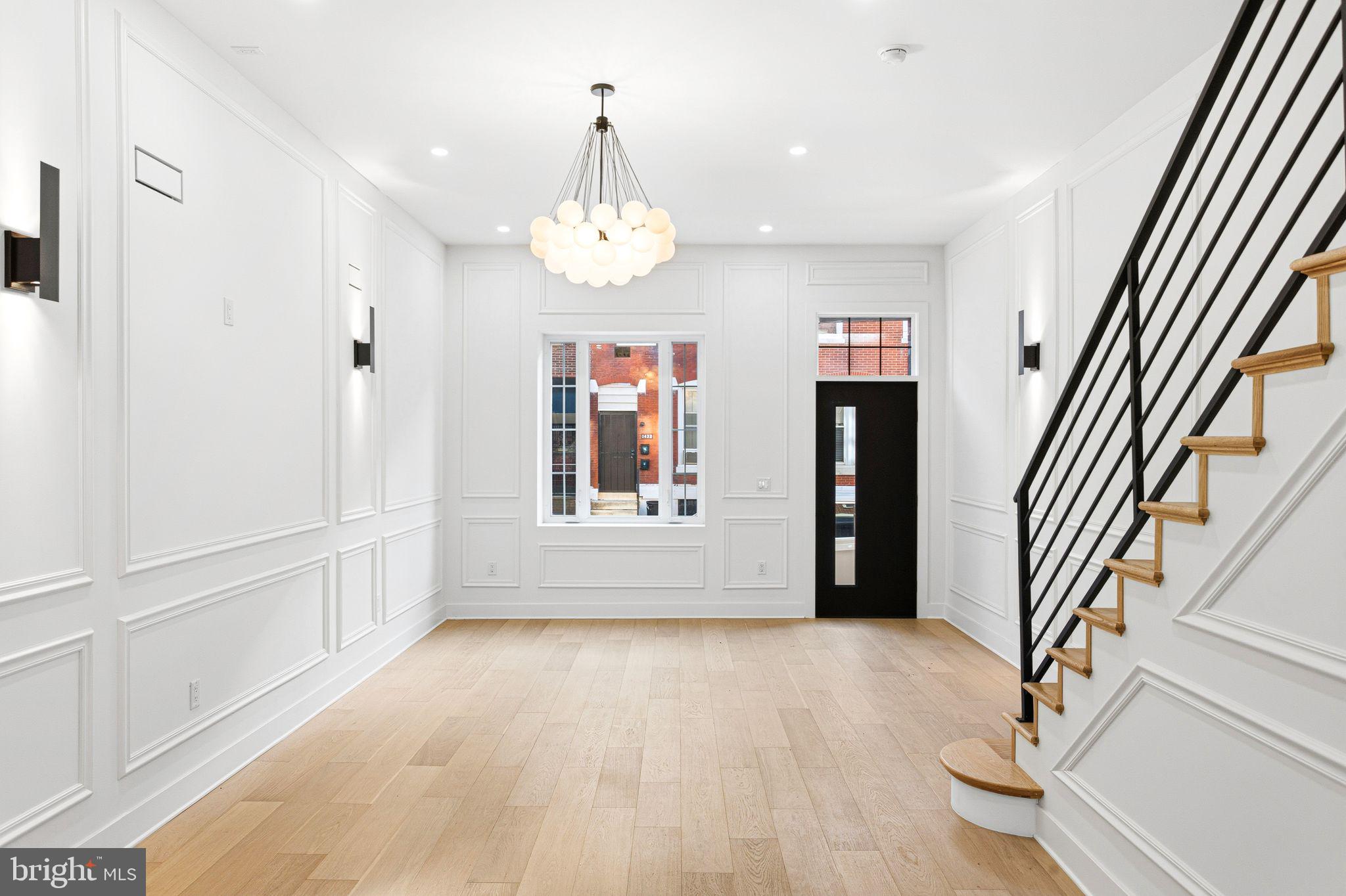 If you’re searching for a home that blends luxury with modern sophistication, your search ends here. Welcome to 1419 Wharton Street—the ultimate urban retreat. This impeccably renovated three-story residence features 4 spacious bedrooms, 2.5 baths, and a bonus room off the primary suite, complete with a wet bar and access to a stunning roof deck showcasing panoramic city skyline views. Step through the front door into an impressive grand living room with soaring 20-foot ceilings, beautifully accented with wainscoting. Just beyond, you’ll find an elegant eat-in gourmet kitchen outfitted with European cabinetry, quartz countertops, and an oversized island perfect for entertaining. The kitchen is equipped with premium slate stainless-steel appliances, a walk-in pantry, laundry room, and a conveniently located half bath. The professionally hardscaped backyard, finished with Greystone pavers, creates the perfect outdoor gathering space. Retreat to the luxurious primary suite featuring a spa-inspired ensuite bathroom with a soaking tub and dual showerheads. All bathrooms boast imported Italian tile, and the entire home is enhanced by custom lighting, designer HVAC vents, staircase lighting, a fully finished basement, and countless high-end upgrades. No expense was spared by this meticulous builder. Located just one block from Broad Street and within walking distance to Center City, Rittenhouse Square, Liberty Place, and all the world-class amenities downtown Philadelphia has to offer, this home checks every box. Don’t miss this exceptional opportunity—schedule your showing today!