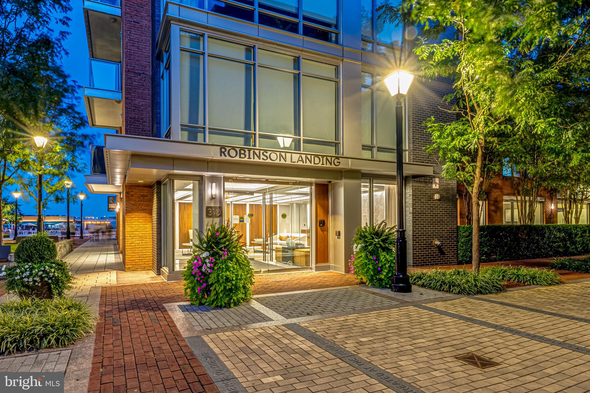 Rarely available waterfront condominium in Robinson Landing offers breathtaking river views and a luxurious lifestyle defined by its proximity to the Potomac River and vibrant riverfront of Old Town, Alexandria.  Step inside to discover a harmonious blend of modern design and comfort. The floor-to-ceiling windows with remote controlled blinds ensure expansive river views and natural light, accentuating the sleek lines and premium finishes throughout. A chef's kitchen, equipped with  high end appliances and gas cooking, invites culinary creativity; and the open floor plan offers a seamless flow into the dining and living spaces, perfect for hosting intimate gatherings or a game-day crowd. European style cabinetry and a waterfall edge island with quartz countertops present a clean, modern profile and make the kitchen space a welcome gathering place. A convenient den/office that can serve as a 3rd bedroom for visiting out-of-town family and friends is just off the living room.   Bonus--custom wallpaper and lighting give this former model unit a distinctive character. Thoughtfully designed to provide both open gathering space and also quiet private space, a hallway separates the serene owner's suite and a 2nd bedroom from the open living area. Two spacious walk-in closets and a spa bathroom with separate soaking tub, seamless glass shower, and a double vanity with lighted mirrors make the owner's  primary suite a welcome retreat. The en suite guest bedroom with generous closet space overlooks a classic Old Town street scene of charming brick residences and street lamps. Robinson Landing exclusive amenities elevate this residence beyond the ordinary. Enjoy peace of mind with 24-hour security and a dedicated lobby desk with on-site staff, private elevator access, and two  assigned and secure underground garage parking spaces .  Other amenities include in-house pet grooming spa, spacious bike room storage and workshop, extra storage space, beautifully appointed meeting rooms and resident lounge with Potomac views, and top-of-the-line exercise and fitness facilities. Above all, the allure of riverfront living is ever-present with the Potomac just steps away, offering picturesque views and opportunities for leisurely strolls to inviting shops and restaurants along the waterfront. Here, luxury meets nature in perfect harmony. Convenient to Reagan National Airport, Amazon HQ2, Capitol Hill, and all Metro D.C. has to offer.