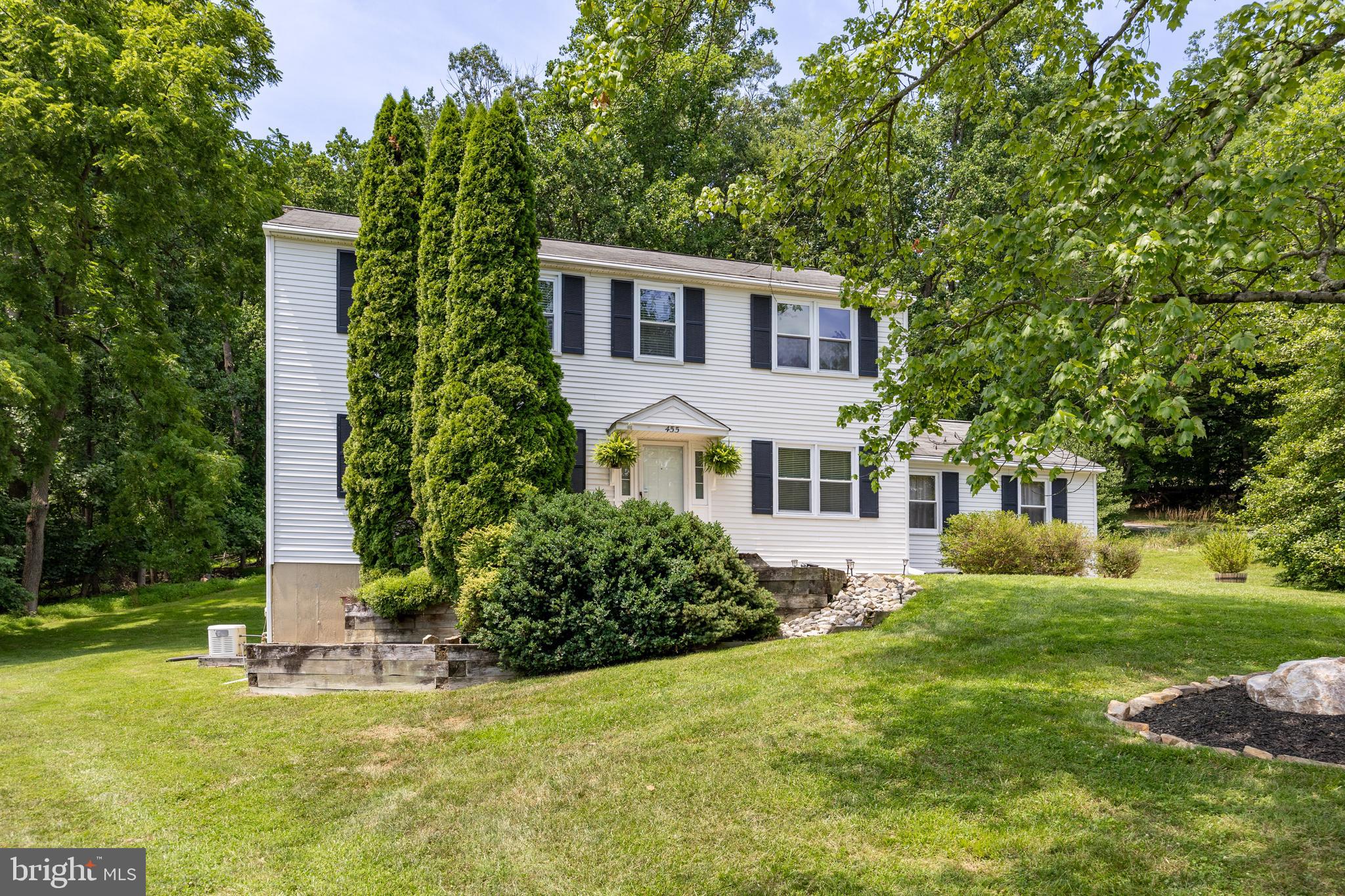 Welcome to 455 Spruce Dr in the quiet sought after neighborhood of Whitford Village! This 4 Bedroom 3 full bathroom center hall Colonial is situated on a lot backed by trees that offers privacy and serenity while being close to the conveniences of Exton. It can be Immediate Settlement!
As you enter the home, flanking on either side is the dining room and a living room that makes a fabulous playroom- French style doors add privacy to this space when needed. Continue on to the kitchen which features custom built cabinet system, quartz countertop, double sinks, tile backsplash, and all stainless steel appliances (Elec stove 2015, D/W 2022, Microwave and LG side by side fridge 2025). A window bench seat that doubles as storage and the laundry/mudroom with access to the deck complete the kitchen.
The adjacent family room has a cozy gas fireplace and access to the deck. Between the living room and kitchen is a renovated full bathroom. As you ascend to the second floor you’ll find a large master bedroom with en suite bathroom and walk-in closet. 3 addt'l bedrooms w/ ceiling fans, a linen closet, coat closet, full bath in the hallway, and attic access complete the upstairs. Additional storage is found in the walk-out basement which makes moving things in and out easy!
Property has a deck on the upper hill that is used for backyard camp outs, kids play area, and a pretty spot to drink your morning coffee and listen to the birds. The property boasts heater/AC 2012, whole house generator 2012, and new water heater 2026.  You have natural gas heat, 2 car garage and maintenance free siding. Close to Mainstreet at Exton, schools, fabulous restaurants, train station, Rt 100, Bypass and 202. Show and Sell!!