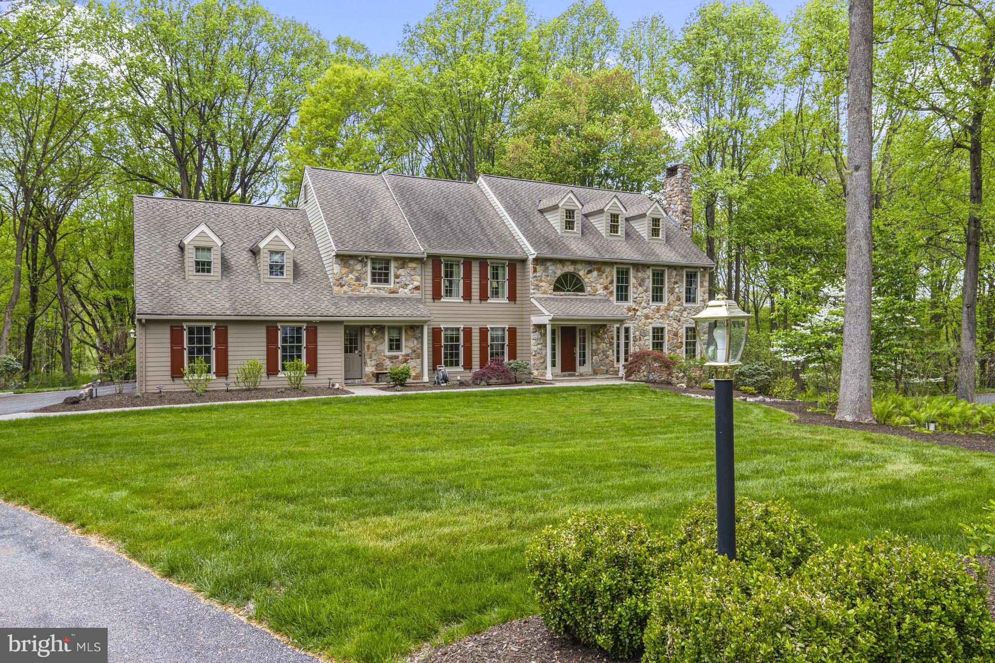 This stunning 5-bedroom, 3 full and 3 half bath traditional home in the highly sought-after Waterglen neighborhood has been lovingly maintained by these original owners! Nestled on a private cul-de-sac and backing to serene wooded space, this home sits on a pristine, meticulously landscaped 1-acre lot with extensive hardscaping. A grand 2-story foyer with a curved staircase welcomes you, flanked by formal living and dining rooms. A private home office with French doors offers the perfect work-from-home setup. The gourmet chef’s kitchen is a true centerpiece, featuring walnut two-tone cabinetry, granite countertops, a large island with seating, a Wolf 6-burner range, additional Wolf wall oven, and a paneled Sub-Zero refrigerator. The adjacent 2-story family room with gas fireplace creates an inviting space for everyday living and entertaining. Hardwood floors run throughout most of the home. Step outside to a newly added composite deck with a spacious screened porch and sleek see-through railings—perfect for enjoying peaceful wooded views. Formal and informal powder room and main floor laundry complete the main level. Upstairs, the luxurious primary suite offers a spacious bedroom, dual walk-in closets, and an updated en-suite bath with jetted soaking tub, tiled walk-in shower, and dual vanities. Three additional bedrooms share an updated hall bath, while a fifth bedroom with private en-suite provides flexible use as a guest suite or bonus room. The expansive finished walk-out lower level offers endless possibilities for recreation, entertaining, or relaxation. Additional features include whole house generator, all Pella windows and doors and all original cedar siding has been replaced with Hardi Board siding. Located in the award-winning Unionville-Chadds Ford School District and convenient to area amenities, this exceptional home combines elegance, comfort, and location.