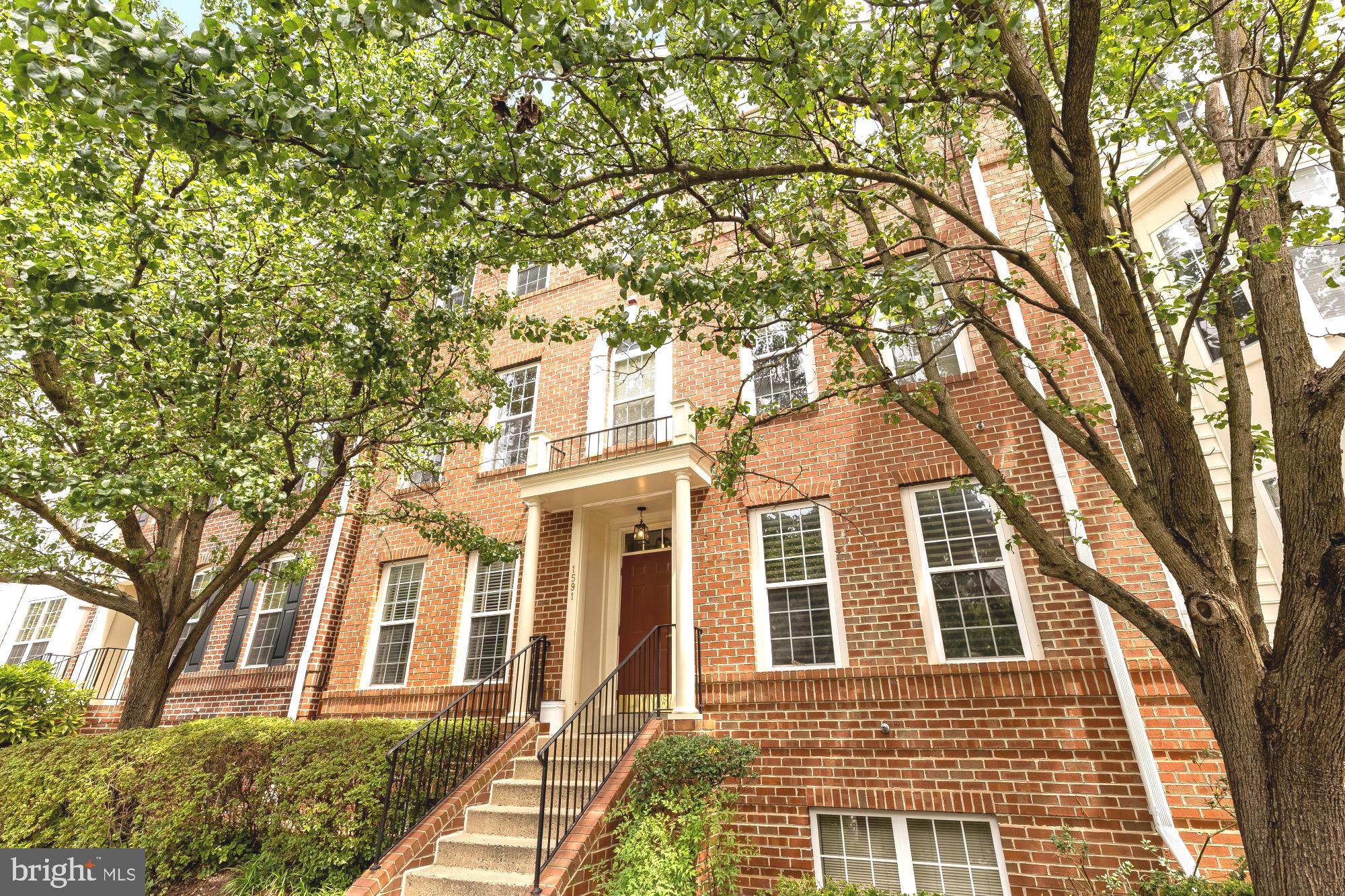 Welcome to 1591 Leeds Castle Drive, Unit 201, located in the sought-after gated community of Westwood Village in the desirable Vienna/Tysons area. This beautifully maintained home features one of the largest and most coveted floor plans in the community, offering a townhome-style layout with the ease and convenience of condo living. The main level welcomes you with hardwood floors, abundant natural light, and an open-concept living and dining area, ideal for everyday living and entertaining. The kitchen features stainless steel appliances, a center island and plenty of cabinet space. Just off the kitchen is a versatile flex space with a cozy gas fireplace, perfect as a family room or home office. A private balcony and a powder room complete the main level. The upper level features a desirable split-bedroom layout with two bedroom suites and a conveniently located laundry room. The primary suite is highlighted by a soaring vaulted ceiling and offers two walk-in closets and a private en-suite bath with double vanity, separate shower and garden tub. The second bedroom also features a large walk-in closet and its own private en-suite bath. Recent upgrades including thermostat (2021), washer & dryer (2021), HVAC (2021 according to the previous seller). Westwood Village offers exceptional community amenities, including a gated entrance, clubhouse, swimming pool, fitness center, and EV charging stations. The condo fee includes water, sewer, trash, recycling, snow removal, landscaping, and exterior maintenance(including roof and balcony), providing easy, low-maintenance living. Ideally located just minutes from Tysons Corner and approximately a 15-minute walk to the Silver Line Metro (Spring Hill Station), with easy access to Route 7, I-495, I-66, and the Dulles Toll Road. Enjoy nearby shopping, dining, and everyday conveniences.