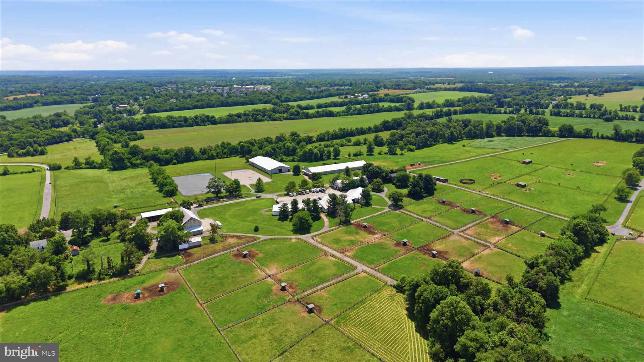 Premiere Equestrian Facility in Poolesville offered for sale for the first time! 
Set on 99 acres the farm boasts two indoors measuring 80x220 and 68x250, two outdoors measuring 150x300 and 125x250 and 75 total stalls.  
The stalls are distributed between four barns, three barns are 50x108 and one barn 34x120.  This barn includes two apartments, one apartment is a 6 bedroom 3 full bath and the other is a 1 bedroom 1 full bath. The farm office and 2 full baths for boarders are on the main level of this barn as well.  Additional buildings include a 30 x 80 bank barn, a 15x48 shed row barn, a 16x 28 run in shed, a 34x70 hay shed and a 30x80 workshop. Four custom made feed bins each holding one ton of feed make storage easy.  There is an underground water holding tank approximately 120x12x6.  All the pastures/paddocks have automatic waterers with power. Most of the property is fenced with board fencing creating 5 pastures and 28 paddocks.
The main home on the property is a Craftsman/Farmhouse style with 4 bedrooms and 2 full bathrooms.
With 3 TDRs included in the sale the new owner can build more homes or sell the TDRs.