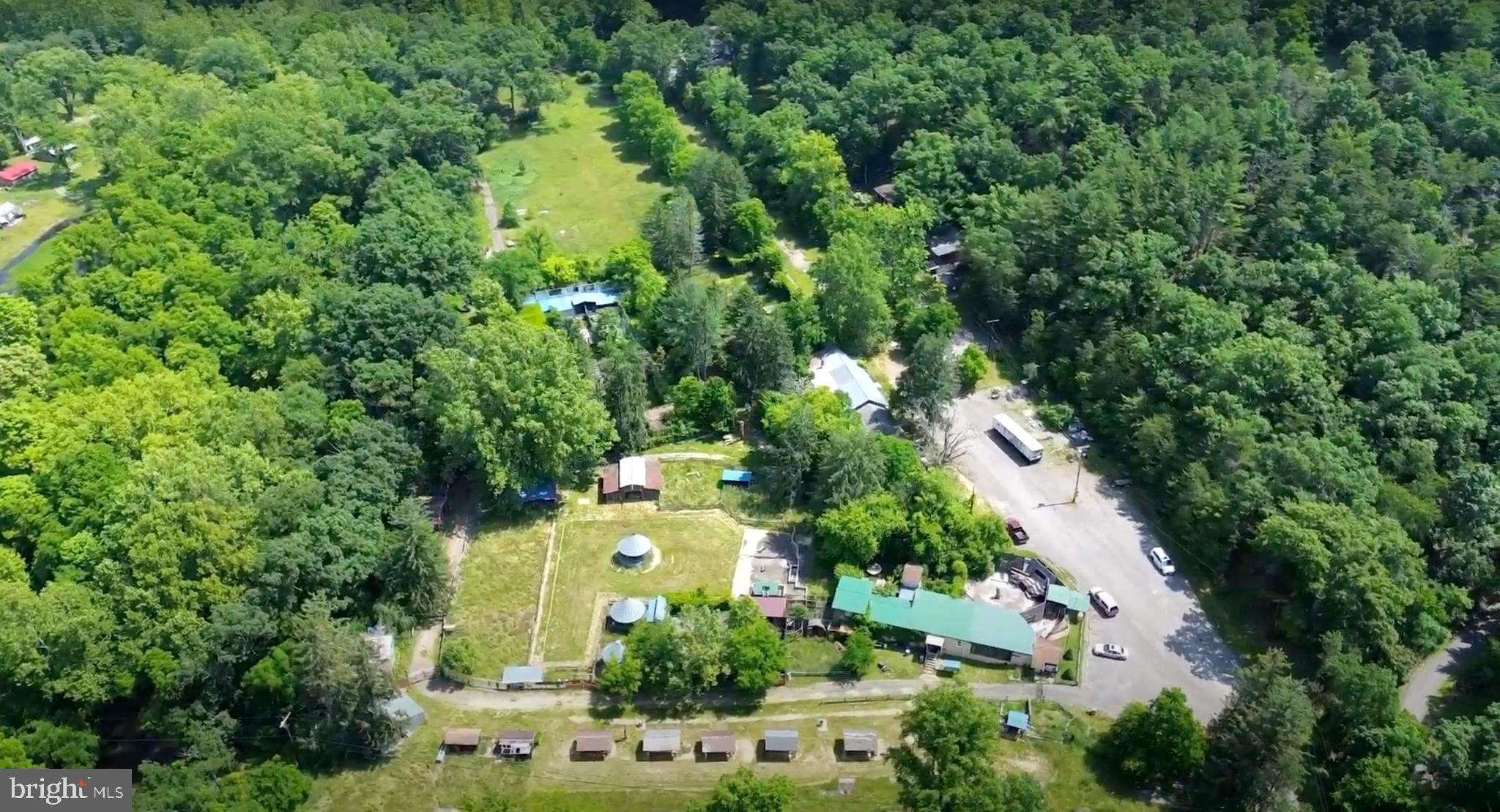 14-Acre Commercial Property with Redevelopment Potential | Western Maryland

Discover a rare opportunity to reimagine this 14-acre commercial property in the scenic mountains of Western Maryland, just outside city limits and minutes from I-68, Downtown Cumberland, UPMC–Western Maryland, and Allegany College.

Formerly operated as a zoo and community center with a pool, the property offers a unique canvas for creative commercial, recreational, or redevelopment uses. Existing improvements—including the main buildings, barn, and a small apartment complex—will require full redevelopment, allowing a buyer to design a project tailored to their vision.

Utilities & Infrastructure Highlights:

Two working wells on the property

One well services three nearby homes, the apartment units, and a mobile home

A second well services various outbuildings and a bathroom on the lower portion of the property

County sewer is available throughout the property

One bathroom currently utilizes a septic tank but can easily be connected to the county sewer

Additional Features:

Expansive acreage with flexibility for a variety of commercial uses

Seller may consider partial financing for qualified buyers

Scenic, accessible location with strong redevelopment potential

Virtual tour available, including aerial views of the property

This is a chance to transform a site with history, character, and scale into something entirely new. Schedule a tour and explore the possibilities.