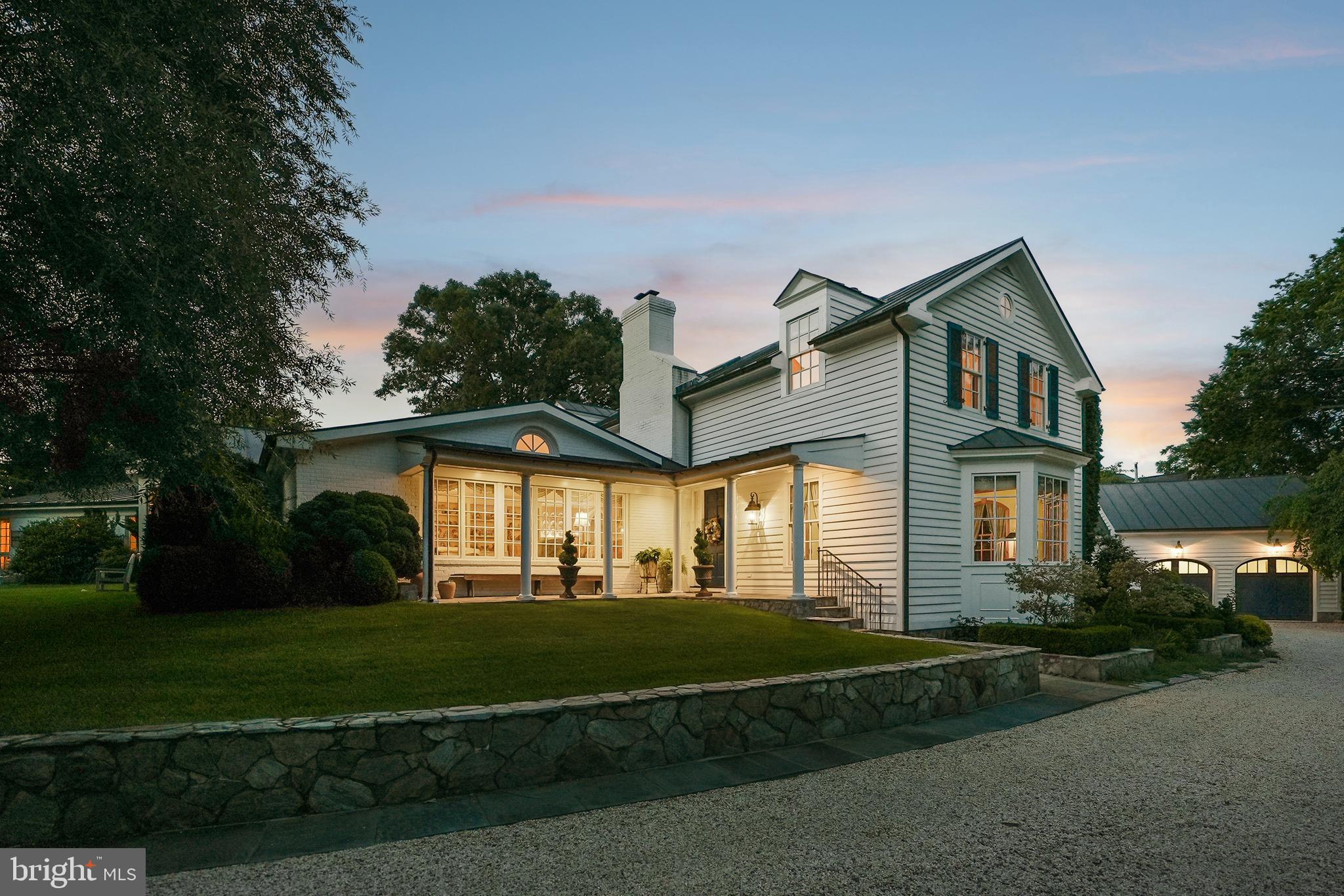 This charming estate is located at the end of a private drive on one of Alexandria's most sought-after streets. Featuring 1.37 landscaped acres, this home offers country estate privacy that is easily accessible to Old Town, Washington, DC, and Reagan National Airport.  

The 5,119 square foot main residence was designed as a spacious classic farmhouse, where every window frames the gardens and extensive lawns. Reimagined by a builder and gardener for their family, the home’s elegant custom architectural details include high ceilings up to twelve feet, centuries-old heart of pine floors and library built-ins, four fireplaces, seven bathrooms and three primary suites. The large kitchen with family/breakfast area includes two working areas with sinks and a cozy office. A first-floor primary suite has a dressing room, two full baths and walk-in closets. Steps away is a laundry/home keeping room with its own outside entrance.

Several outbuildings are integral parts of the estate’s charm and unique character- a lovely guesthouse adjacent to the in-ground pool area, an oversized two-story garage with attic and four storage bays and a custom imported glasshouse from England. The setting of the property, its privacy and improvements, would make you think it was the Virginia countryside! 

The property's grounds feature several gardens, which were showcased during the national Garden Conservancy's 2025 Open Days event. Stately oaks, boxwoods, topiaries, rare conifers, shrubs and a woodland walk ensure year-round interest in the landscape of this legacy property
