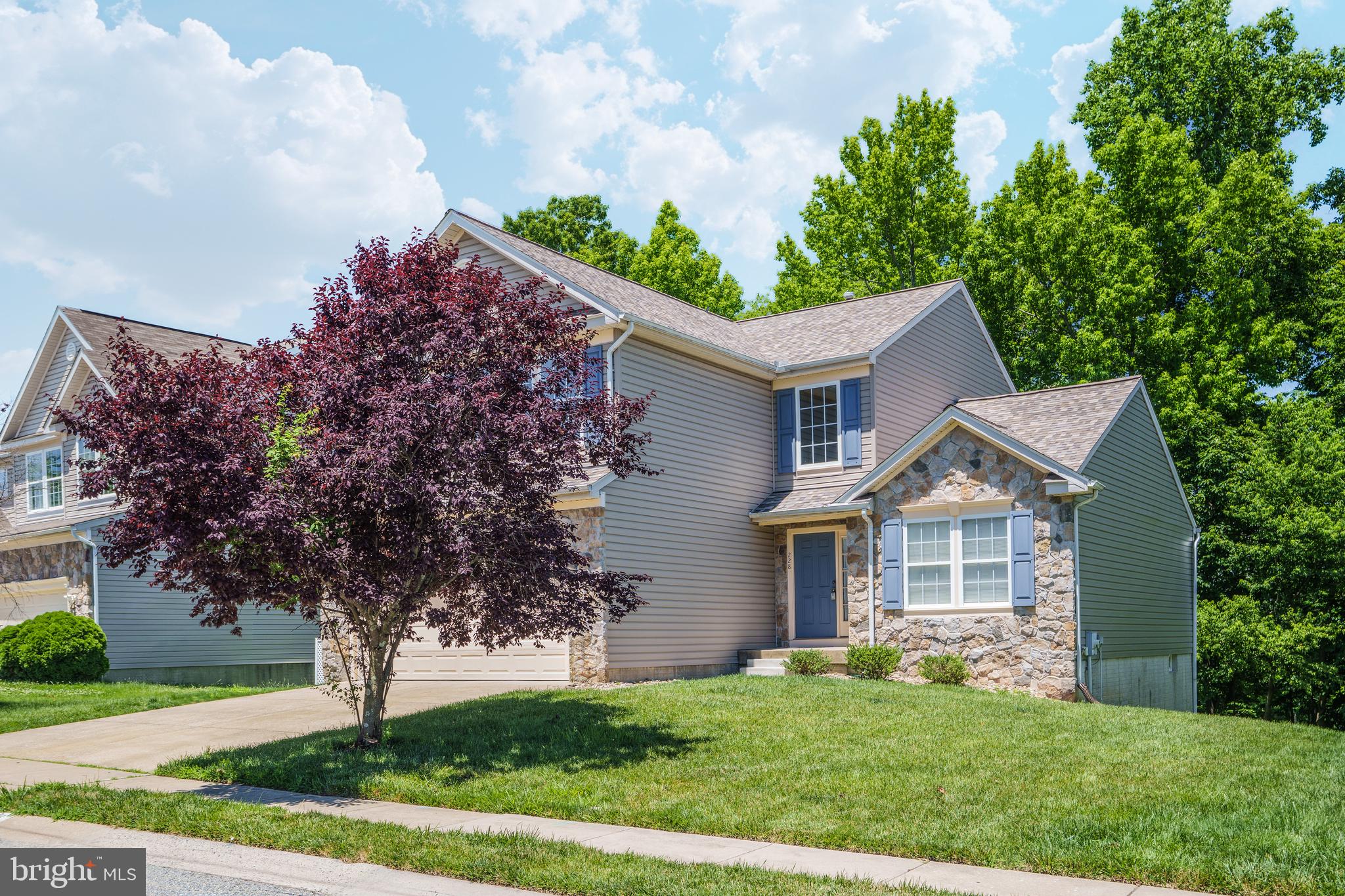There's no place like home in this 5-bedroom, 3.5-bath home in Patriots Glen. A two-story tiled foyer welcomes you inside and leads to the eat-in kitchen, which features updated countertops, stainless steel appliances, tile flooring, and plenty of cabinet and counter space. Just off the kitchen, the family room includes a gas fireplace, while sliding glass doors lead to the composite deck with vinyl railings overlooking the backyard. Hardwood floors add warmth to the formal living and dining rooms. Upstairs, the spacious primary suite includes room for a sitting area, a walk-in closet, and a private bath with a soaking tub, walk-in shower, and dual vanity. Three additional bedrooms and a full hall bath complete the upper level. The mostly finished walk-out basement expands the living space with a large recreation room featuring a wet bar, a fifth bedroom, two bonus rooms, and a full bath with a walk-in shower. Additional features include a main-level laundry room, an attached 2-car garage, and a new TruDefinition® Duration® Designer AR roof installed in 2026. Residents of Patriots Glen enjoy access to community amenities including an outdoor pool, tennis courts, playgrounds, and beautifully maintained common areas. Patriots Glen Golf Club, the Tavern, and the Launch Zone driving range are also located within the community. Just minutes from shopping, dining, and major commuter routes, this home combines generous living space with a convenient location. Schedule your private tour today and see everything this Patriots Glen home has to offer.