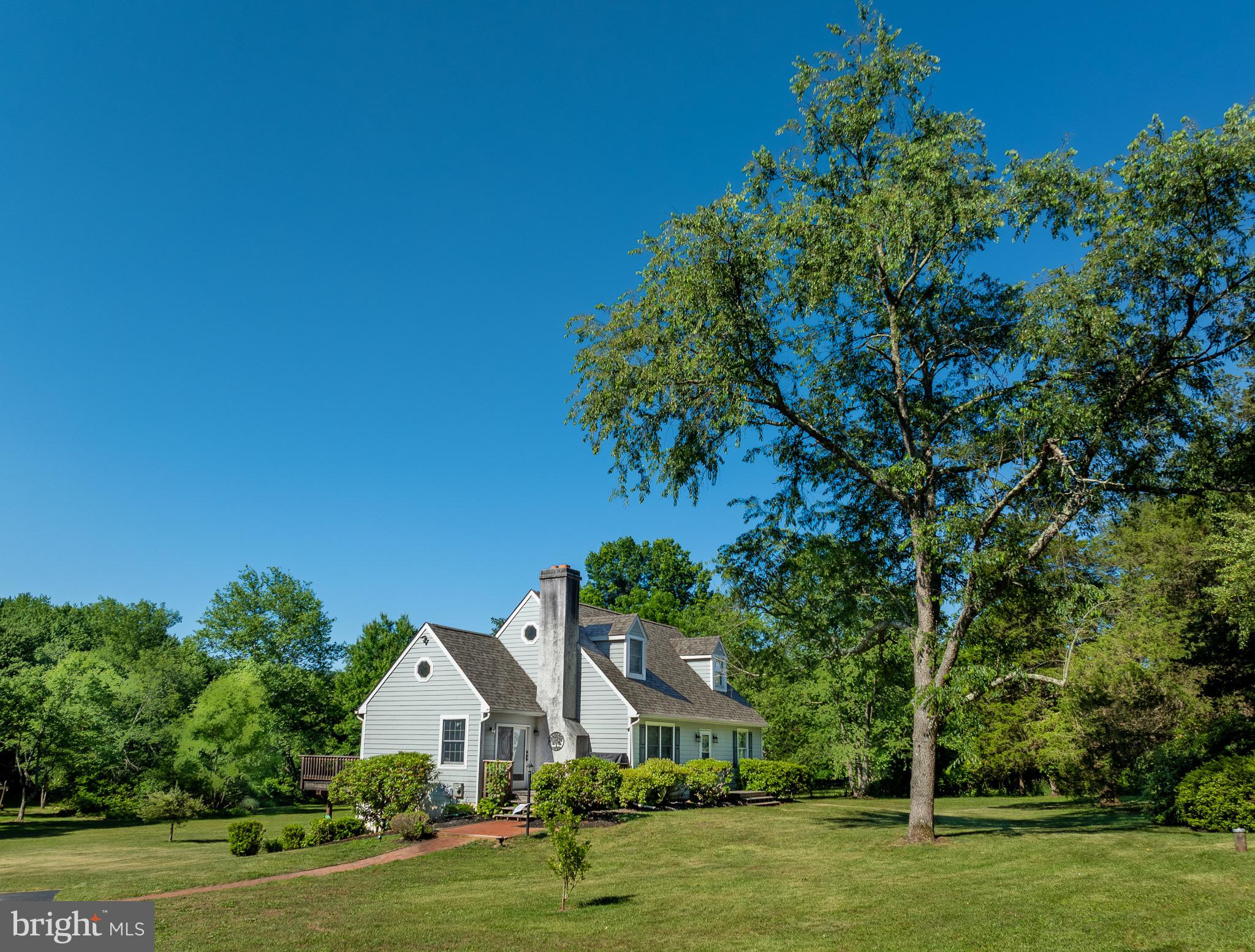INDOOR PHOTOS COMING SOON! Come explore 10+ acres at 776 Cobb Hill Lane, a well-maintained Cape Cod offering the feeling of a peaceful retreat in Owen J Roberts School District. Only 5 minutes from the High School, supermarket, and local shops. Enter the expansive, private property via a long, paved drive. Step through the front door into the spacious living and dining area featuring cathedral ceilings, an impressive wood-burning stone fireplace, and hardwood floors. Large windows, skylights, and the open floorplan fill the home with an abundance of natural light, while sliding doors lead to a large deck overlooking the stunning yardspace and tree-covered stream. Just off the main living area, enter into the kitchen which includes a side entrance leading to a second deck — the perfect spot to enjoy a quiet morning coffee. The main level also includes two bedrooms and a full bathroom, while the upstairs loft hosts the primary suite. 

The basement offers a laundry area, half bath, and ample space for storage, a workshop, or future recreation room. A sliding glass door provides direct access to the backyard, where expansive lawn space and a wooded stream create an inviting setting for outdoor entertaining, exploration, and enjoyment of the property's surrounding land. Notable upgrades to the house include refinished hardwood floors and all new bedroom carpeting installed in 2024, a new roof in 2024, newer HVAC system installed in 2022, and a newer deck and Hardie Board siding completed in 2019. The existing barn, currently used for small farm and yard equipment storage, could easily be converted into a horse or livestock barn. Ample land surrounding the barn could be used for pastures, fields, or even the potential to build an additional residence. Enrolled in Act 319, this beautiful property is ready for its next owners to enjoy the cozy charm and peaceful outdoor setting it has to offer!