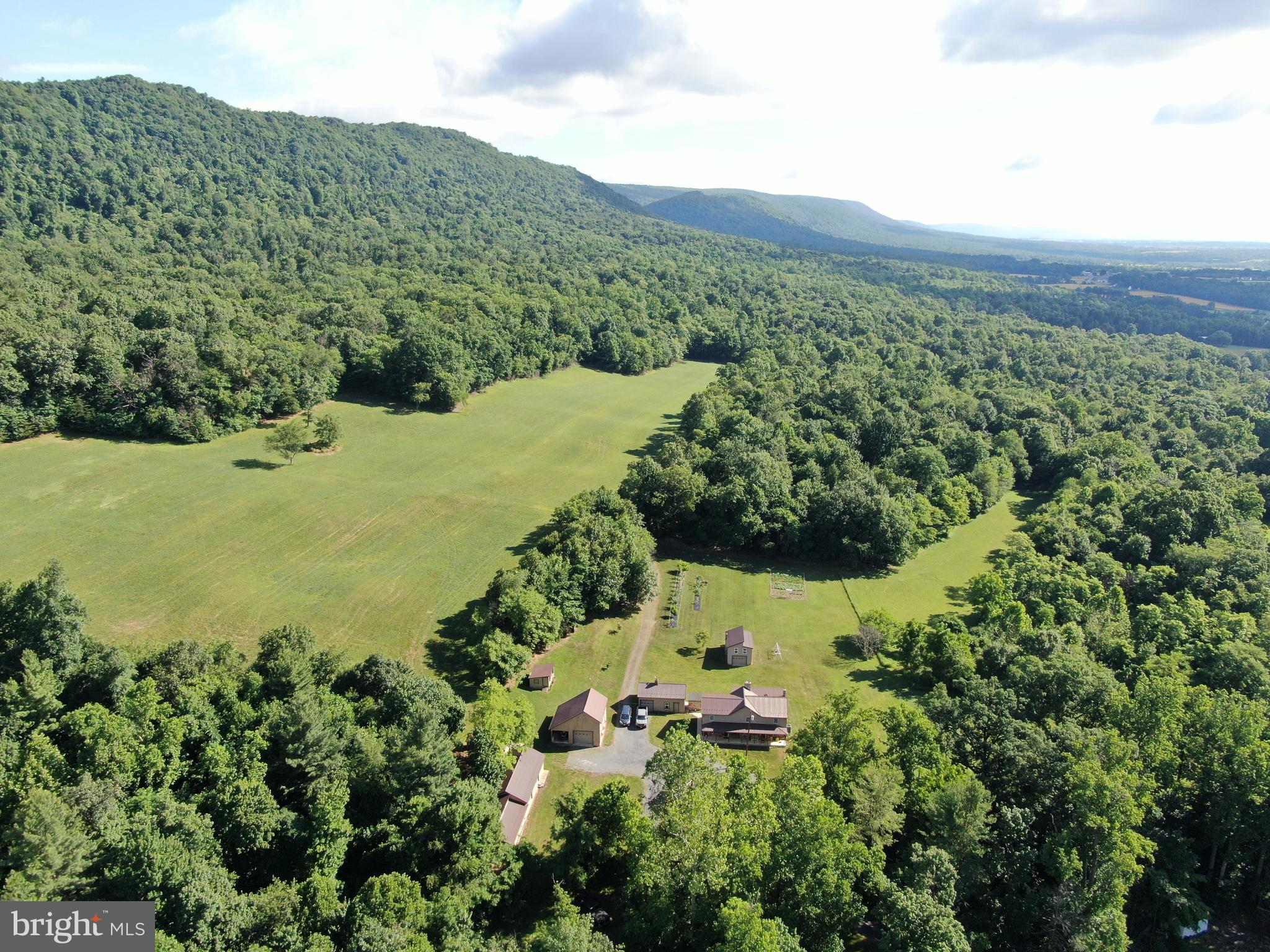 AMAZING 56± ACRE PROPERTY WITH A SPACIOUS HOME! – ENJOY PEACEFUL COUNTRY LIVING! This exceptional property offers the perfect blend of  tillable land, wooded land, and outstanding recreational opportunities. The property features approximately 12 acres of tillable land currently utilized for hay production, with the balance in wooded acreage. The wooded land provides excellent hunting and wildlife habitat with abundant deer, turkey, and bear. Groomed trails extend throughout the property, making it ideal for hiking, ATV riding, horseback riding, and enjoying the outdoors. The spacious home features 5 bedrooms, 2 full bathrooms, a kitchen, dining room, living room, laundry room, basement, and a large family room with cathedral ceilings and a sliding door leading to the patio. Numerous outbuildings including a wood shed located beside the outdoor wood stove, a wagon shed/garage with two garage bays, one equipped with an automatic garage door opener and loft storage, a summer kitchen/garage featuring an overhead door, fireplace, loft, and attached smokehouse, a garden shed/garage with overhead door ideal for mower and ATV storage, and a 20' x 40' shop with 110 and 220-volt electric service, overhead door, and attached chicken house. The property also features a large garden and approximately 15 fruit trees, providing an excellent opportunity for gardening, homesteading, and enjoying fresh produce right from your own backyard. The property is well-suited for a variety of agricultural uses, including horses, cattle, and other livestock.  The property features frontage along Circle Drive and also benefits from deeded right-of-way access to the rear of the property, providing convenient secondary access and making it easy to reach hunting and recreational areas. Offering privacy and seclusion while remaining conveniently located just minutes from Route 30, Chambersburg, St. Thomas, and surrounding amenities, this is a rare opportunity to own a versatile country property with endless possibilities.

This property will be offered at auction on Thursday, August 6, 2026, at 3:00 PM. The list price in no way represents a minimum, starting, or acceptable bid.

This property will be offered in a multi-parcel auction, giving buyers the flexibility to purchase Tract 1, Tract 2, or both tracts. Tract 1: 56+/- Acres with a spacious home and outbuildings, Tract 2: .59+/- Acres vacant land, would make for a beautiful home site.