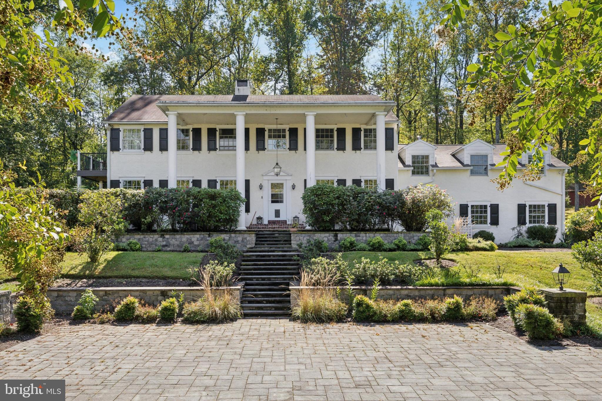 This stately Colonial home, set on an impressive 5 acres, offers a perfect blend of modern updates and classic charm. The main house features a thoughtfully designed addition that includes a spacious three-bay garage with finished living space above, along with a luxurious primary suite renovation complete with an exquisite bathroom. The stunning kitchen, remodeled in 2022, and all-new Pella windows enhance the home's appeal. The first floor is designed for both formal and casual living, boasting a formal living room, dining room, family room, breakfast room, sunroom, and a large recreation room, complemented by three powder rooms, a mudroom, and laundry facilities. 2 Fireplaces (wood burning FP in the Family Room & gas FP in the Breakfast Room). Upstairs, the master suite with an en-suite bathroom is accompanied by three additional bedrooms and another full bathroom.  The charming terrace off the master provides picturesque views of the expansive property.  A quick stroll to the inground pool and you will find a pool house equipped for entertaining, wood fencing, and a sun-drenched pool. The current owner completed a large-scale front courtyard installation perfect for entertaining & additional parking as needed.   Additional highlights include a whole-house generator, 400 AMP electric service, New Pool pump (2023), Pool renovations: tile, coping, plaster, & mechanicals (2009), Security System (2021).  Septic system was new in 2009.  Too many upgrades to list them all !!   A 1000-gallon in-ground propane tank is owned and conveys with the property.   The land comprises two parcels, with the main house situated on 3.6 acres and located in Charlestown Township and the Great Valley School District.  An additional 1.4 acre parcel is included in the sale, and is in Schuykill Twp.  This is a truly special property and home.