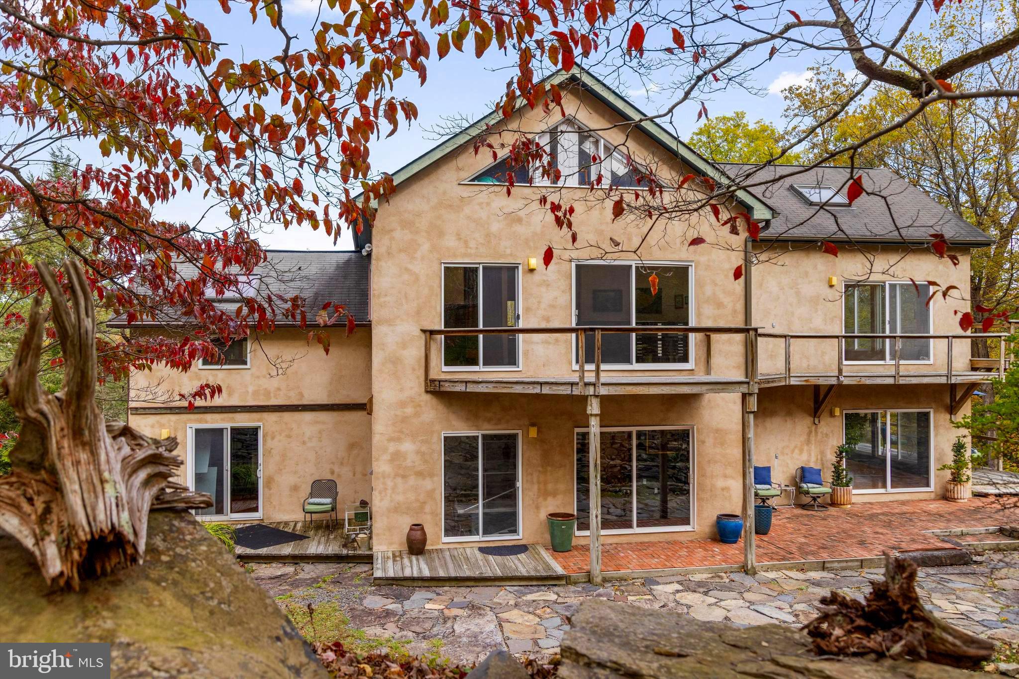 A rare Bucks County property a four unit property offering endless possibilities for creative living, extended family, or entrepreneurial ventures. Set on a hillside with panoramic views of nature and seasonal glimpses of the Delaware River, this unique estate includes multiple residences with flexible spaces ready to inspire. The Main House is a modern and spacious 3-bedroom home with sweeping views — a peaceful retreat overlooking the river valley. The Carriage House contains a garage and studio above. The Gable House is a charming 2-bedroom dwelling full of character that is income producing or could be used for extended family and guests. The Barn House is a versatile building featuring income producing studio apartment and a 2-bedroom apartment — ideal for rentals, workspaces, or artist residencies. With so many living options, the property is well-suited for multi-generational families, collaborative households, or those seeking live/work flexibility. Artists and entrepreneurs will find abundant space to create, host, or generate income.
It's just a short walk to the Delaware River and the riverside village of Point Pleasant, with direct access to the towpath for biking and hiking. Nearby, enjoy the vibrant cultural scenes of Frenchtown, NJ, New Hope, PA, and Doylestown, PA.
Commute time is under 2 hours to NYC, 80 minutes to Philadelphia, and 50 minutes to Princeton — making this the perfect retreat or full-time residence for those looking to blend work, creativity, and lifestyle.