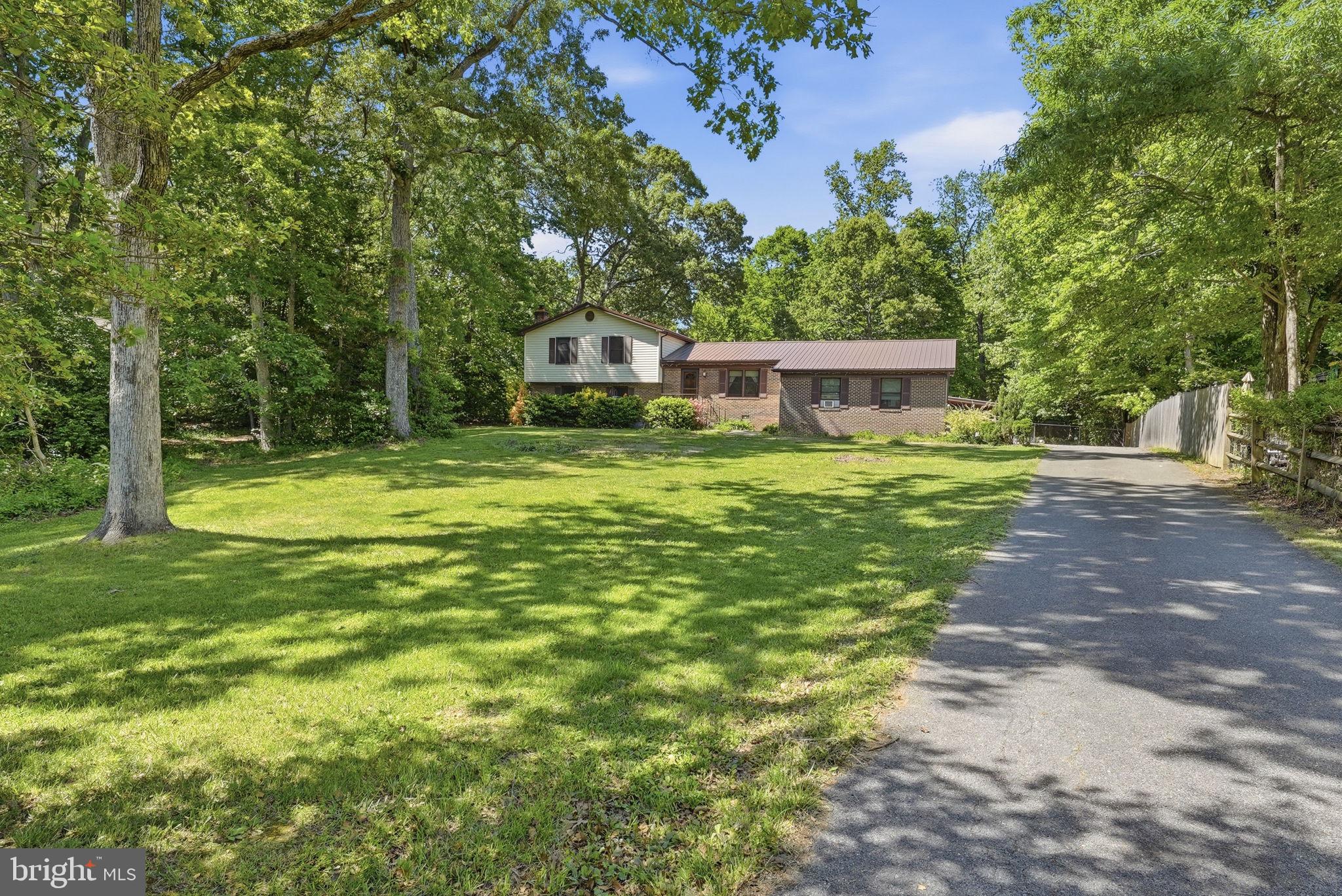 This home is an incredible value at this price!!! You can walk through the front door into the heart of the home - the dining room and kitchen coming to life with the sounds and smells of home. (Maybe you want to move dining back into the eat-in kitchen and add a main level living room.) Or you can slide through glass doors from the back deck. The 400 sq ft addition has a whole variety of uses, its own entrance, and a wood burning stove.  Once a recording studio, it makes a perfect spot for movie night, game day, rowdy play dates, or working from home behind glass. Inside the main home, you get a primary bedroom and bath plus two additional bedrooms and a hall bath to share upstairs. Downstairs, a den, and additional separate rooms for storage, crafts, work or guests complete with laundry and a third full bath. Great for wet feet coming in from the hot tub too! Plenty of paved parking for gatherings with friends, and tons of storage or room to work in the 24X24 ft detached garage. All in a prize location convenient for Chaptico Park, the library, amish markets and even a golf course.  Polished and paved community of nice homes perfect for going for runs, yet private and just rural enough you can have chickens and never worry about an egg shortage again. Welcome Home!
