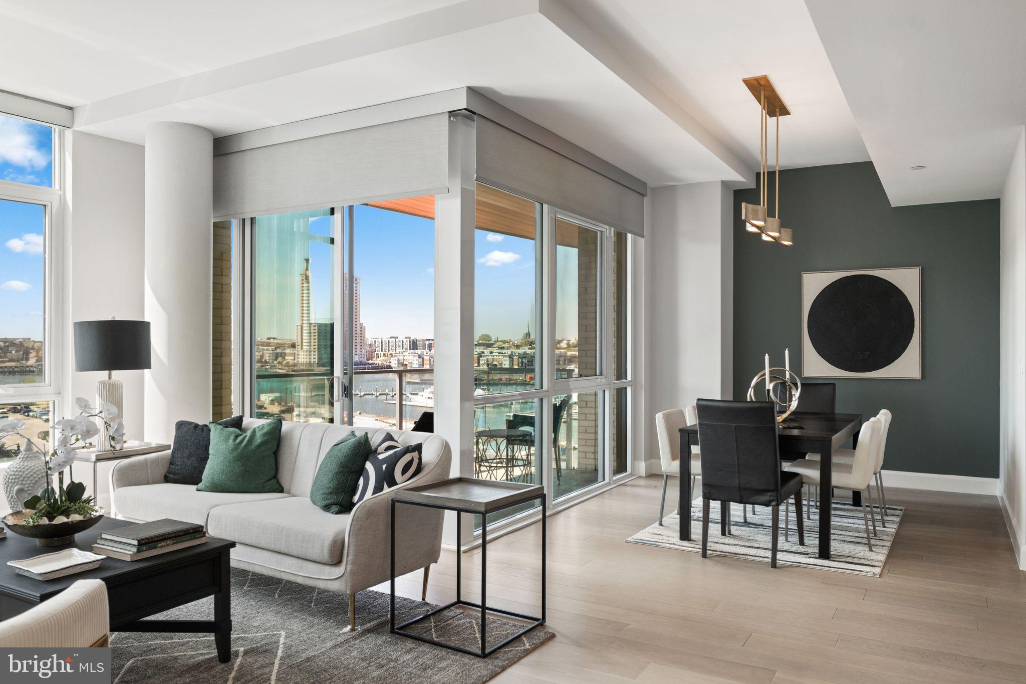 Experience luxury waterfront living at Liberty Harbor East! This stunning 2-bedroom, 2-bath residence offers over 1,500 square feet of sophisticated like-new space. With breathtaking panoramic views of the city and water, this is one of the few units in the Liberty to enjoy a private balcony off of the main living area. The unit is ideally situated in the building to maximize harbor views while providing a calm and quiet retreat in the heart of Harbor East. This smart home features soaring ceilings, oversized windows, wide plank oak floors, and a custom mirrored media wall with TV and gas fireplace. The spacious chef’s kitchen boasts Italkraft cabinetry, Thermador appliances, and a waterfall marble island- perfect for any home chef! The spacious primary suite offers floor-to-ceiling windows, a custom California Closet, and a spa-like en-suite bath with Carrara marble, Kallista & Kohler fixtures, and dual vanity. A split layout ensures privacy within the unit. The second bedroom is generously sized with a walk-in closet and an additional hall full bathroom. One garage space is included in the purchase. Residents enjoy unmatched amenities at the Liberty including a rooftop infinity pool, state of the art fitness center, pet park, concierge lounge, private dining, and direct access to Whole Foods. Steps from top dining, shopping, and waterfront paths—this is the ultimate downtown lifestyle.