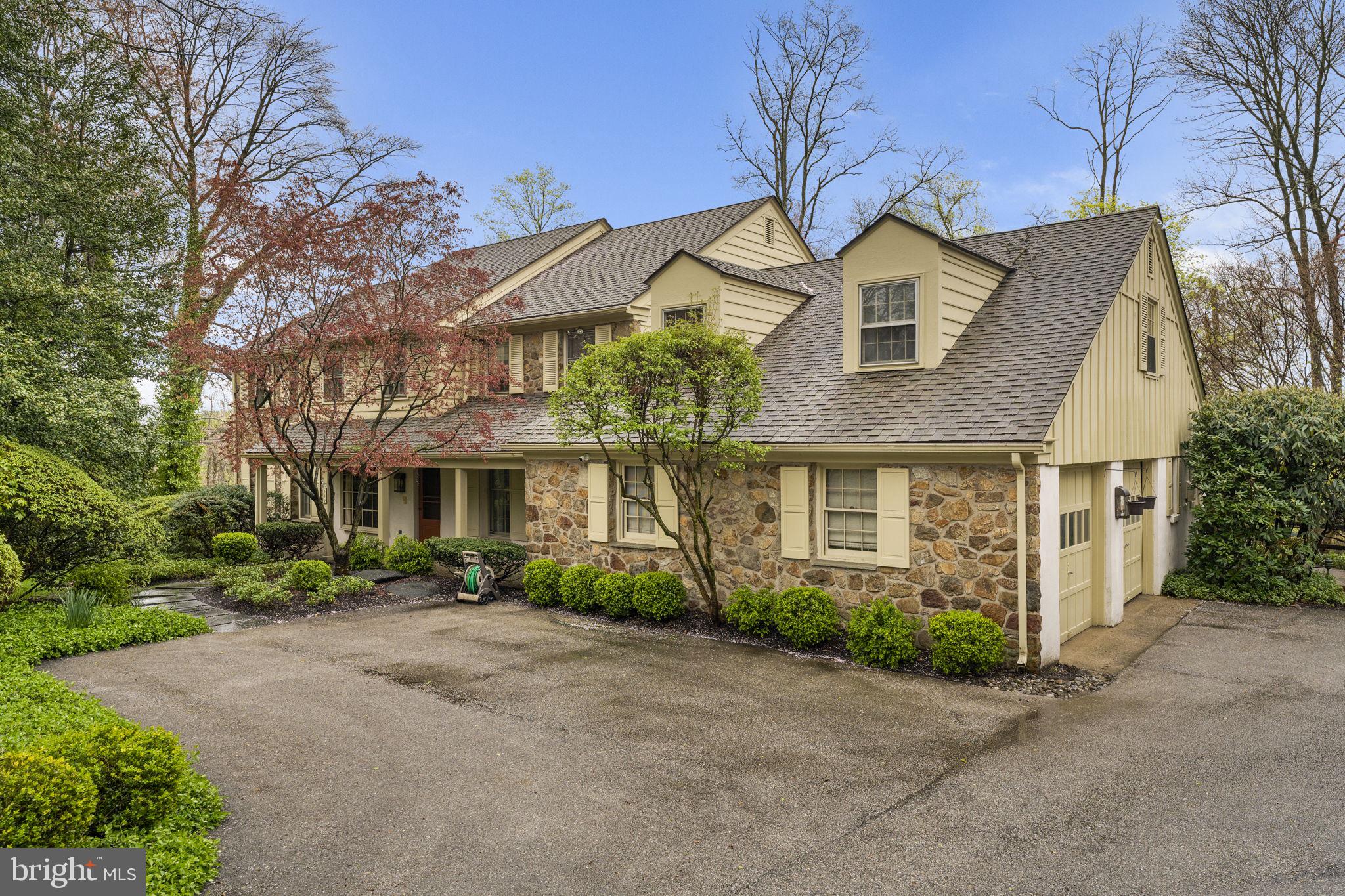 Park-like grounds and updated interiors create an inviting residence nestled on a beautiful cul-de-sac in Bryn Mawr. Inside the 4,600 square-foot residence the entry way introduces the living and entertaining spaces highlighting details that include hardwood floors, carpeting and millwork throughout with tremendous attention to detail. Upon entering the foyer, you are brought to the center of the home. The Dining Room has abundant natural light, two built ins and easy access to the Kitchen, Family Room, and Living Room.  The formal Living Room has beautiful windows, sliding doors that access the back brick patio providing access to the rear yard.  The stunning kitchen is a gourmand’s delight with crafted cabinets, quartz topped counters, working island with storage, and top of the line appliances including a Thermador range, double ovens, Bosch refrigerator, dishwasher, beverage refrigerator, and large sink. An adjacent sun-filled breakfast nook welcomes casual dining and has access to the back brick patio through sliding doors. Adjacent to the kitchen is a mud room with large closets, an office, full bathroom, and access to the two-car garage.  The family room houses a wall of windows and sliding doors, hardwood floors, a striking stone, wood burning fireplace, perfect for cozy gatherings. 
The second floor provides Five Bedrooms and Two full Baths.  The Primary bedroom has beautiful windows and a new (2019) bathroom and walk in closet.  The bathroom has double sinks, custom cabinetry, a large shower, and access to a private balcony with awning.  The views from the balcony are breathtaking, highlighting the private back yard.  The second Full bath was updated in 2022 and has double sinks, custom cabinetry, and a large tub/shower combination.  There are two large linen closets and well as a third deep storage closet in the main hallway for ample storage.  Each of the other bedrooms have large closets and hardwood floors (some under carpeting).  The attic is accessed from the hallway and provides additional storage.  
The walk out Lower-Level houses the laundry, large family room area, and other rooms that can be used for additional offices, exercise area, bedroom, or storage.  The setting and yard set this home apart.  The back yard is fully fenced and has a heated plaster in ground pool.  There are multiple patios and entertaining areas that allow for any outside activity. This home has a new roof (10 yrs.), HVAC replaced in 2022, Hot Water heater in 2023 and a whole house Generator installed in 2020.  The attention to detail and care is evident throughout the home creating unique settings for entertaining as well as the living spaces any family desires. The location is close to shopping, the airport, and schools. Numerous parks are close by - Ashbridge Park that has over 28 acres dedicated to playgrounds, running trails as well as tennis and sledding. Stoneleigh is up the street and features 42 acres available for exercise, picnics, and horticulture. The Harriton House and The Appleford Estate also add additional historical and recreational options. The combination of the private setting with the accessibility of these amenities creates a perfect balance for today's family.