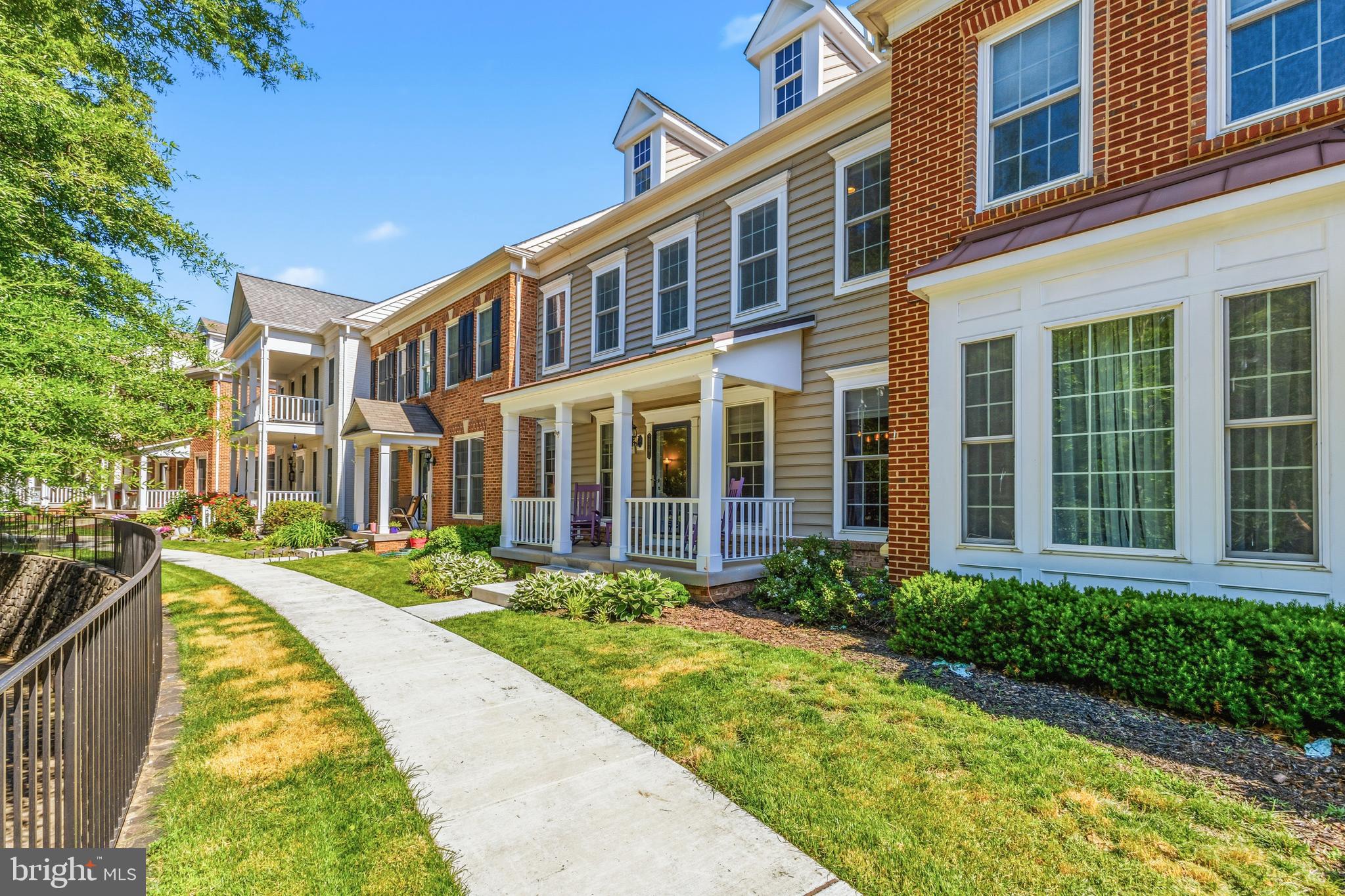 Beautiful Pulte built townhome tucked in the Red Cedar community of Leesburg - enjoy the the view of the lush green park & meticulous landscaping from your covered front porch! As a resident you enjoy the pool, fitness area, lawn cutting and common areas. Residents can tailor their own front flowerbeds to their delight! This well-loved home offers three levels, an attached 2 car garage and a spacious rear patio to enjoy barbecuing and a beverage! From the time you enter the foyer you notice the unique details of a Pulte built home with beautiful wood floors on the main level, crown molding, chair rail and wainscotting. Enjoy entertaining in  the dining room with custom light fixture. The butler's pantry is adjacent to both the kitchen & dining room with granite countertops and additional cabinetry offering the perfect serving or coffee/tea station. The open kitchen has granite counters, ample cabinetry with soft close cabinets, new backsplash (Spring 2026), pantry and stainless steel appliances. Full of charm - the custom pendant lights, "barn" wood paneling and custom swivel bar stools make for a cozy dining spot at the breakfast bar. Newer kitchen appliances include the Bosch Dishwasher & Kitchen Aid Fridge with Ice maker. Open family room with gas fireplace and custom mantel surround added in 2024. Upstairs offers an expansive primary suite with a trendy barn door,  ceiling fan, tray ceiling, recessed lights and walk-in closet. The primary bathroom has a soaking tub, large shower and a granite vanity with dual sinks, updated lighting & framed mirrors. The remote control blind in the bathroom adds an extra bit of privacy and ease. Two additional spacious bedrooms with  generous sized walk-in closets & ceiling fans added in 2019. A second full bathroom with granite counters and a tub/shower. Upper level laundry - washer/dryer convey, dryer replaced recently. The lower level has a large finished rec room space with recessed lighting, full bathroom and an egress window with steps out. The large unfinished storage/workshop area  could be made into your own gym space, workshop or finish it into a media room or however meets your needs! Garage freshly painted with auto openers & added in 2022 is a 240v garage circuit for an EV charger. Other notable updates/items of note: kitchen backsplash (2026), custom antique fireplace surround (2024), main home roof (2023), water heater (2022), HVAC serviced bi-annually,  newer dishwasher, refrigerator & dryer. Updated lighting (2020), ceiling fans (2020), smoke detectors (2019)  & added barn door. The home has an active radon system already installed. AS-IS conveyance items include the alarm system, storage room wooden work table & white peg board as well as the kitchen/butler pantry area calendar organizers. Items that do not convey include: the EV charger, green overhead garage retractable power cord, rolling workbenches in the storage area & the free standing yellow & white storage shelves in the basement unfinished area.