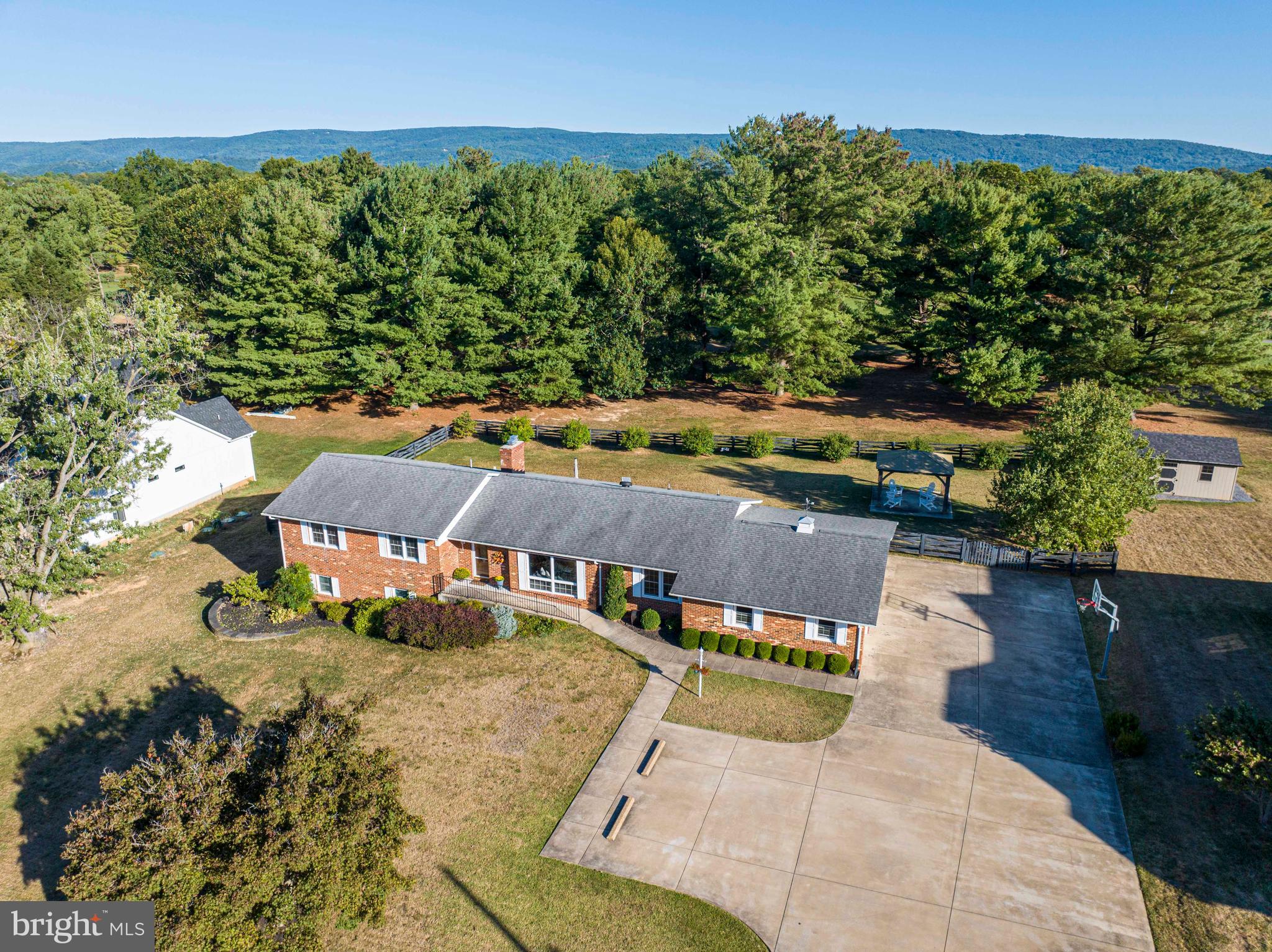 Gorgeous 2-level Brick Rambler is quietly nestled on the 9th Fairway of the Shenandoah Valley Country Club & Golf Course in Front Royal. This home provides over 3600 sq ft including a 2-car garage with a concrete driveway, extra parking spaces along and additional room to park your RV or boat. Owner's pride shows both inside and out.   Main floor boast hardwood flooring throughout along with 3 ample sized bedrooms and 3 full bathrooms and gas fireplace with remote to curl up on a cold, winter day. The kitchen features stainless steel appliances, double wall ovens, gas cooktop, granite countertops, a screened-in-porch which leads out to the fully manicured fenced backyard. Enjoy entertaining small & large gatherings on your oversized Trex deck while relaxing in your saline hot tub or just enjoy the great views and additional entertaining space with the stunning gazebo. The lower level has a fully finished basement, bedroom (although not official), 1 full bathroom, laundry room and a second living room, as well as a recreational room with a wall of custom walnut built-ins, additional remote gas fireplace and double doors that open up to your large backyard. This is a great opportunity to own a home that provides many upgrades and amenities for your every need.   Enjoy a round of golf, or Firepit Fridays at The Shenandoah Valley Golf Club.  Minutes from, shopping, restaurants, downtown, I-66 & I-81 . Upgrades & amenities include tankless water heater, upgraded electric, a heat pump with oil backup and a new 500-gallon underground (owned propane tank for the 2 fireplaces), newer windows, newer roof and 2 sump pumps.  Work from home not a problem, Xfinity high speed internet is available.
