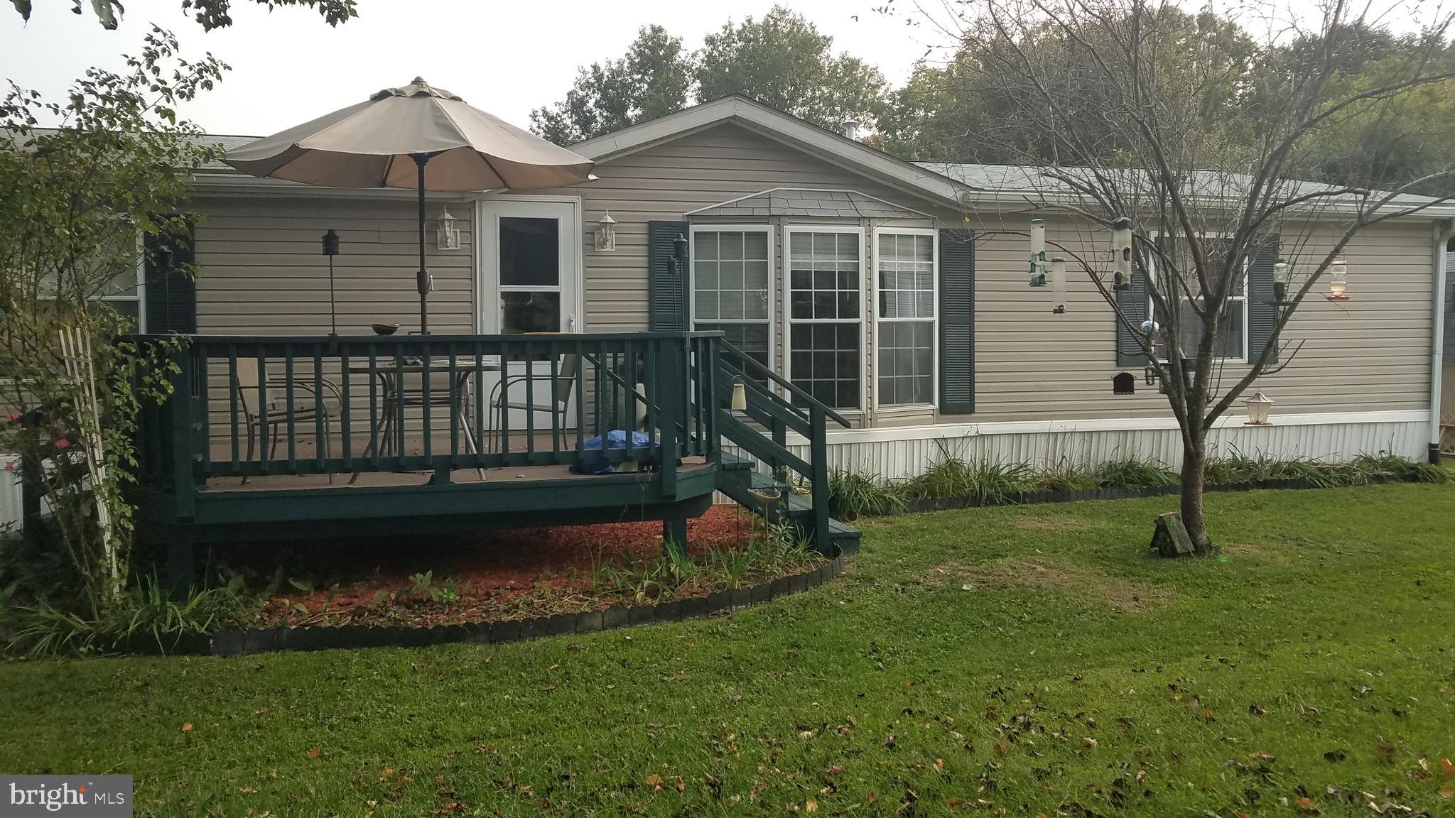 Very Nice 3 BR,  2 BA double wide manufactured home in Hillandale Homes. New wood flooring, new carpet in the 2nd and 3rd BR. All appliances are only 3 to 5 years old. 4 car carport and a nice shed located in the back of the very flat yard that backs to woods. Shed has electric. Site rent is $661.00 per month which includes water, septic and trash removal 2x per week. Must be approved by Community Manager.