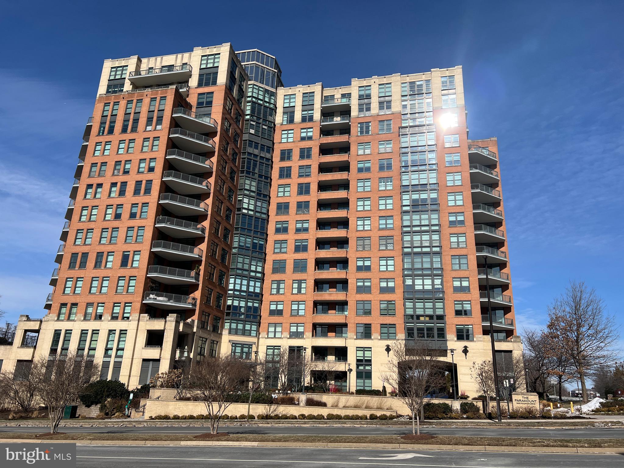 No need to look any further...A fantastic opportunity to live at the Paramount at Reston Town Center!  If you are looking for a lovely 2 bedroom, 2 bath floor plan with incredible city views and super location, this is the property for you!  Many spectacular city views of the Reston Town Center from this luxury condo & the spacious balcony.   This 1,369 sqft Phoenix model has a gourmet kitchen, adjoining living room with gas fireplace, separate dining room--a rare find in a condo--for your most formal entertaining, breakfast bar for a casual meal, morning coffee or a cocktail, very spacious master bedroom with large walk-in closet that boosts a quality organizer system, master bath with double sinks, soaking tub & separate shower, nice-sized secondary bedroom, hall bath, in-unit washer/dryer room that provides extra storage and newer LVP flooring & carpet.   The Paramount is a premiere condo building offering utmost luxury, convenience & fine living experience...Building amenities include an outdoor pool, fitness room + strengthening room, a club/party room, lovely outdoor patio space off club room & pool.  Walk across the street to all of the fabulous amenities offered by Reston Town Center from fine & casual dining to shopping & great entertainment.  Also nearby is the RTC Metro stop, W&OD bike path, library, additional shopping & dining opportunities & coming soon just across Fountain Drive... Whole Foods.  Dulles International Airport is within 10 miles and you can take the metro there if you prefer.   Location...Location is an under statement.  Make this wonderful property your new home and start enjoying life in Reston!  Quick closing possible!
