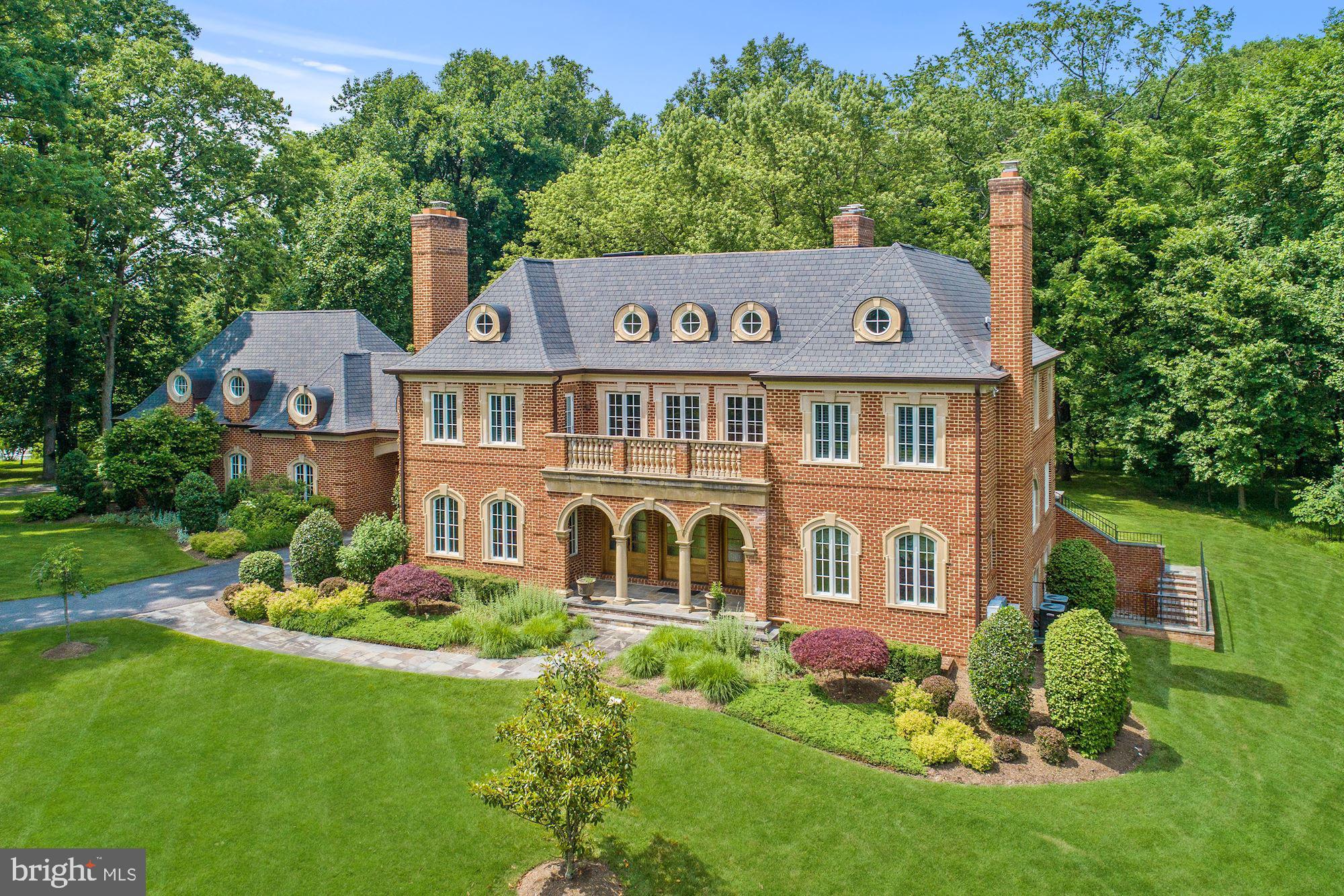 This estate is situated on 4.8 acres of lush land with over 7,000 square feet of living space. The property features 6 Bedrooms with 6 Full and 2 Half Bathrooms including a in-law or rental suite. There is also a custom 4 car garage, backyard barn, and an 11 seat movie theater. The main level includes a grand two story foyer with formal living and dining rooms both with wood burning fireplaces. The foyer opens up to the large family room with another wood burning fireplace, custom coffered ceiling, and walk-out to the huge stone terrace and backyard. This is truly a home for entertaining and embracing the indoor/outdoor lifestyle. There is a gourmet chefs kitchen with stainless steel Viking brand appliances and huge custom island with granite counters. There is also a sunny breakfast area with room for a large table for informal gatherings. The upper level of this home includes 4 bedrooms all include attached baths and balconies. The master bedroom has vaulted ceilings with skylights making it bright and inviting. You also have another wood burning fireplace and a private balcony overlooking the backyard. The ensuite bath includes custom tile work with double sink vanity, soaking tub, and walk-in shower with rain heads. You also have a huge walk-in closet with dressing area. The upper level also features a large laundry room that includes additional storage space. From the upper level you also have access to the in-law/guest/rental suite. This suite includes 1 bedroom and 1 full bath with a separate private entrance and laundry. Hardwood flooring throughout with a full kitchen and living area as well. The lower level of this home is fully finished with a walk-out to a large stone patio and walk-up to the backyard. Enjoy the stone wood burning fireplace and your own built-in bar. The lower level also features an additional bedroom and full bath. The bonus of this space is the 11 seat custom theater perfect for entertaining friends and family! The grounds of this home are spectacular and feature a barn with ample space for parties, storage, or other recreational activities. There is also a built in trampoline and a basketball hoop off the large circular driveway. Located within minutes to shopping, restaurants, and public transit. Don't forget to check out the virtual tour of this stunning home.