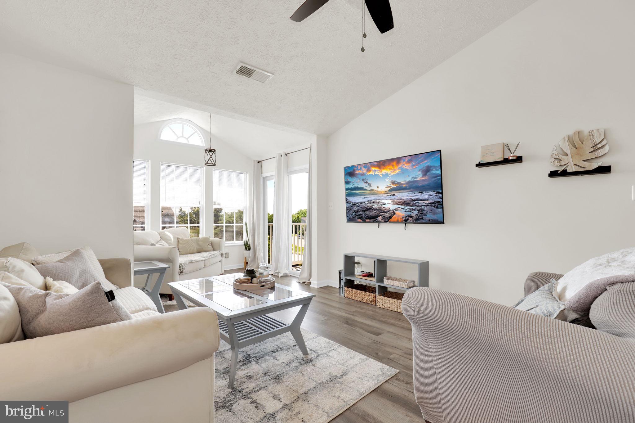 Welcome home to this beautifully updated top-floor condo, where soaring vaulted ceilings, abundant natural light, and an open-concept layout create a bright and inviting living space. The stylish kitchen has been refreshed with new countertops, a modern backsplash, and upgraded appliances.

Luxury vinyl plank flooring flows throughout the home, leading to a spacious primary suite complete with a walk-in closet and private en-suite bath. A second bedroom and full bath provide flexibility for guests, a home office, or additional living space. Enjoy the convenience of an in-unit washer and dryer, plus assigned parking located directly outside the entrance.

Perfectly positioned near shopping, dining, parks, and major commuter routes, this move-in-ready condo offers the ideal blend of comfort, convenience, and low-maintenance living—with the added bonus of no city taxes. Don't miss your opportunity to make this exceptional home yours!