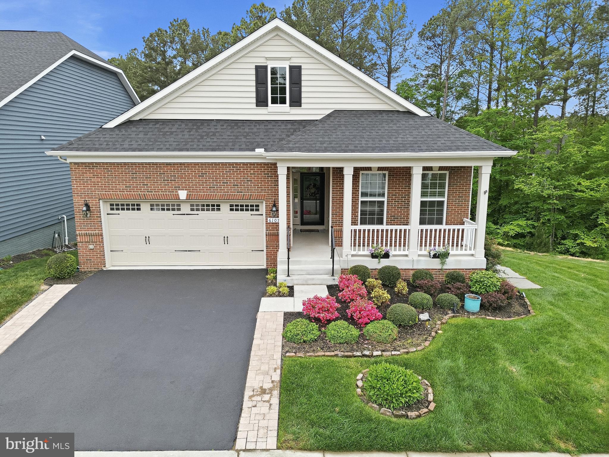 ​Welcome home to 6107 New Berne Road! This spectacular 5BR/4BA home in Fredericksburg's premier 55+ community of Virginia Heritage offers an extraordinary blend of thoughtful upgrades and resort-style living. Impressive hardwood flooring flows throughout the main level, setting an elegant tone from the moment you step inside. The chef's kitchen impresses with upgraded granite counters, stainless steel appliances, and custom floor-to-ceiling built-in cabinetry that delivers exceptional storage and style. The open-concept main level flows beautifully into the living and dining areas, anchored by a main-level primary suite featuring a spacious en suite bath and dual walk-in closets. Step outside and prepare to be wowed: an expansive two-story covered composite deck backing to trees sets the stage for year-round entertaining, while impressive hardscaping and a serene koi pond create a private backyard oasis. Whole house water filtration and treatment system. The fully finished basement is an entertainer's dream, complete with a stylish wet bar, a fifth bedroom and full bathroom, and generous living space perfect for guests, a hobby studio, or a home theater retreat. Virginia Heritage amenities including indoor and outdoor pools, fitness center, pickleball and tennis courts, a clubhouse, and scenic walking trail are just steps away, with easy access to I-95, shopping, and dining. Homes with this high level of finished space and outdoor living rarely come available. Schedule your private tour today!