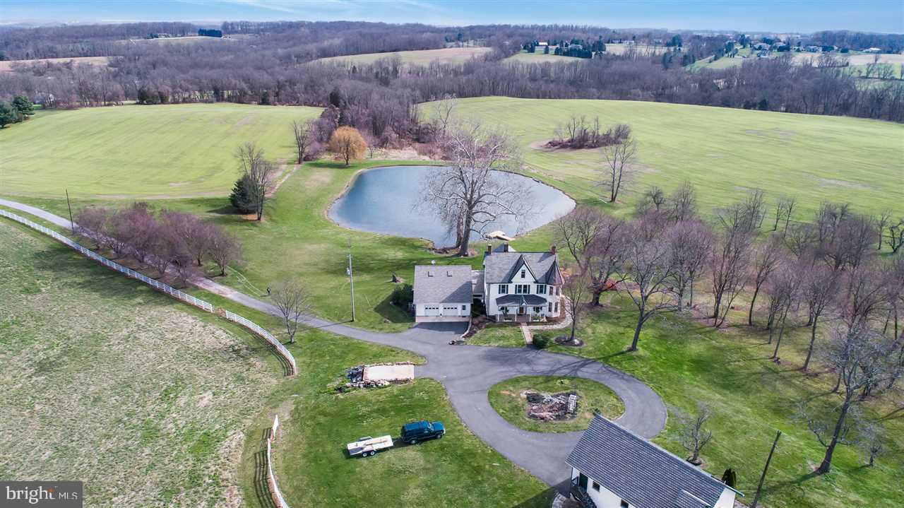 This private remodeled farm house sitting on 20 acres has so many updates and additions.Newer kitchen w/ corian and ceramic.  Large FR with game room loft, gas fireplace and oversized windows that overlook the 1 1/2 acre pond. HW floors throughout. Many original interior stone walls and stone fireplace. 25X40 2 story building possible in-law quarters. 5 acre pasture with run in shed. Entertaining is easy with seating up to 25.