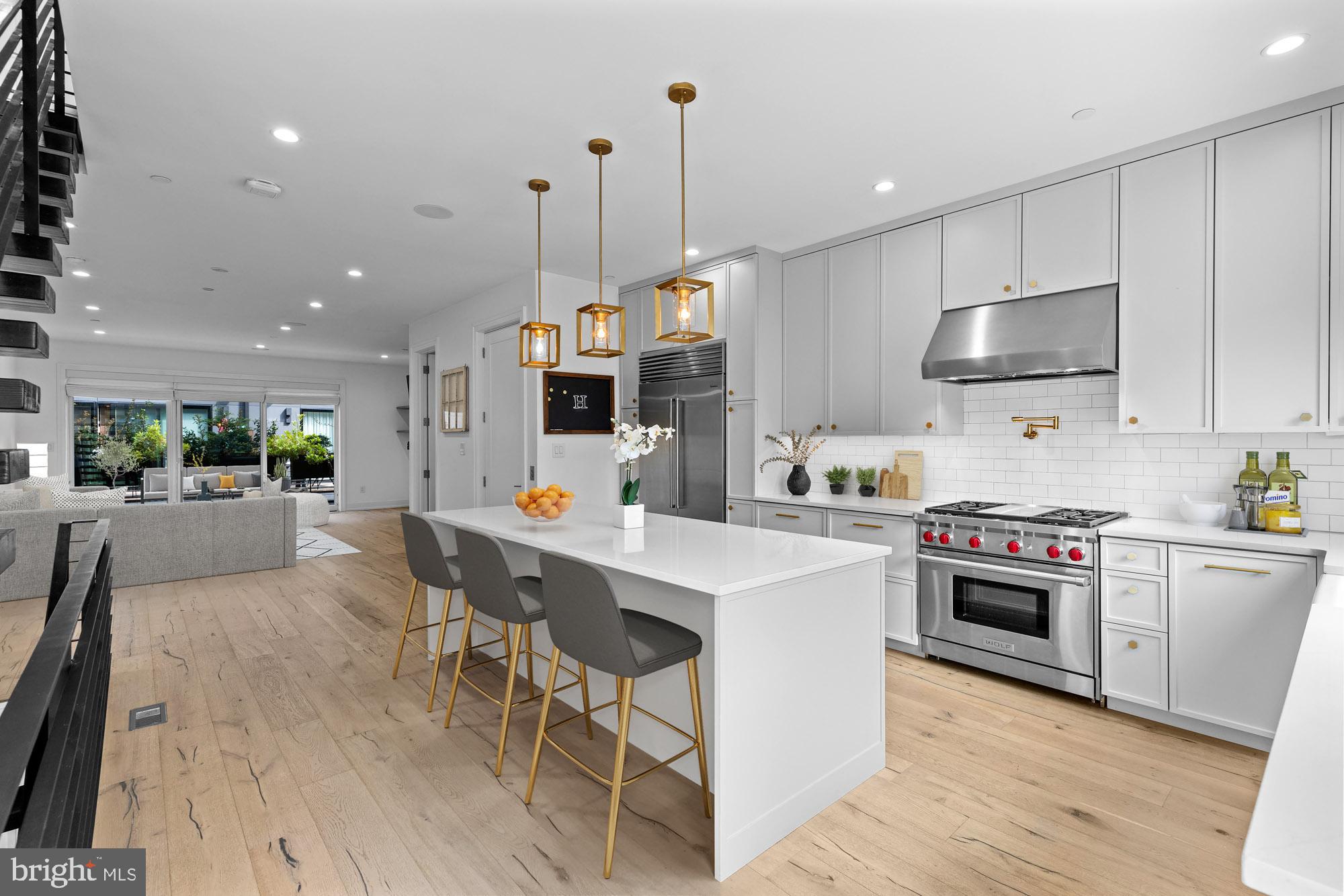 Luxury city living at its best in this gated townhome community. This 4200 sq ft open floor plan with an abundance of natural light, fireplace, and 2 car garage that has 5 years left on the tax abatement is a must-see! Wide plank floors are throughout, a chef's kitchen with a Wolf stove and cooktop, a Sub Zero refrigerator, and an island workspace. All bedrooms have walk-in closets with custom shelving. The owner's suite and designer bathroom with a soaking tub is total relaxation. Plenty of entertainment spaces with either the 1st floor deck or the rooftop deck with a half bath and wet bar. Owners upgraded and replaced the decking and the rear sliders and windows.  There is a 3rd option too! The basement is currently being used as a movie room and the big screen and projector are included! Kater Court has a walking score of 10 to the Avenue of the Arts, restaurants, and shopping while also conveniently located to major highways and shore points. Pack your bags!