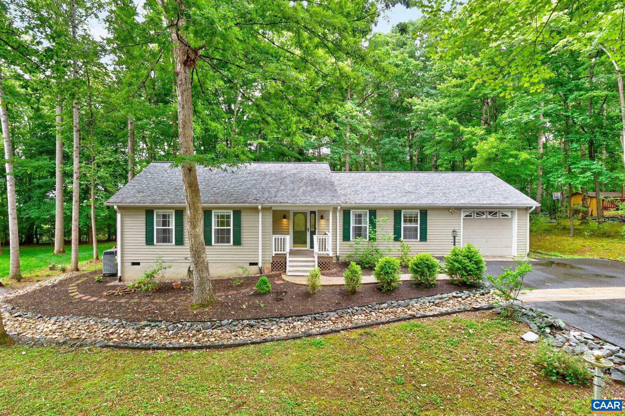 Riverside Beauty.  If you're looking for that "just the right size" one level home with spacious rooms yet manageable....this home is for you. Situated in the Riverside Section of Lake Monticello, featuring 1440 sq ft with an open concept living area, oversized Primary suite and 2 more spacious bedrooms, on a level lot with private backyard.  Well maintained, including a paved driveway and 1 car garage with storage space above, this home is waiting for new owners. Natural light fills the rooms skylights in the main living area. Estate sale May 16, 9-3 and May 17 12-4.,Formica Counter,Oak Cabinets