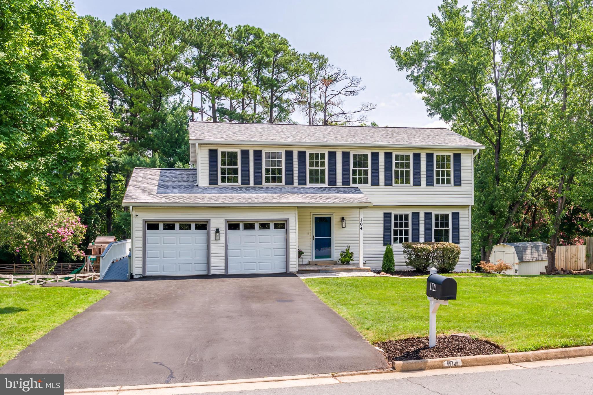 This is the one buyers wait for! Built and lovingly cared for by its original owners, this beautifully refreshed 5-bedroom, 3.5-bath Colonial offers approximately 2,880 finished square feet, a rare multigenerational layout, and a peaceful 0.46-acre setting in Sterling’s welcoming Foxlee community.

The bright main level features refinished hardwood floors, fresh paint, updated lighting, and an inviting kitchen with refreshed cabinetry, new appliances, and backyard views that make everyday moments feel special. Sip your morning coffee while watching birds gather in the mature trees and deer visit the pear tree just beyond the window. Upstairs, four spacious bedrooms include a comfortable primary suite, while brand-new carpet (2026) gives the entire home a fresh, move-in-ready feel.

The lower-level suite is the showstopper—complete with its own private entrance, full kitchen with new appliances, spacious living area, bedroom, and full bath. Thoughtfully created for true multigenerational living, it also offers exceptional flexibility for extended guests, independent living, a private office, or recreation space.

Outside, enjoy two levels of decking, a stone patio, landscaped walkways, outdoor lighting, a large storage shed, and a spacious backyard surrounded by mature trees. Major improvements include the roof (2019), HVAC (2024), five-inch seamless gutters (2025), and shutters (2025), offering comfort and peace of mind for years to come.

Foxlee is the kind of established neighborhood where neighbors still wave during evening walks, yet Route 28, the Dulles Toll Road, Dulles International Airport, shopping, dining, parks, and the Silver Line Metro are all just minutes away. Space, versatility, nature, and convenience come together beautifully at 104 Magnolia Road—don’t miss this one!