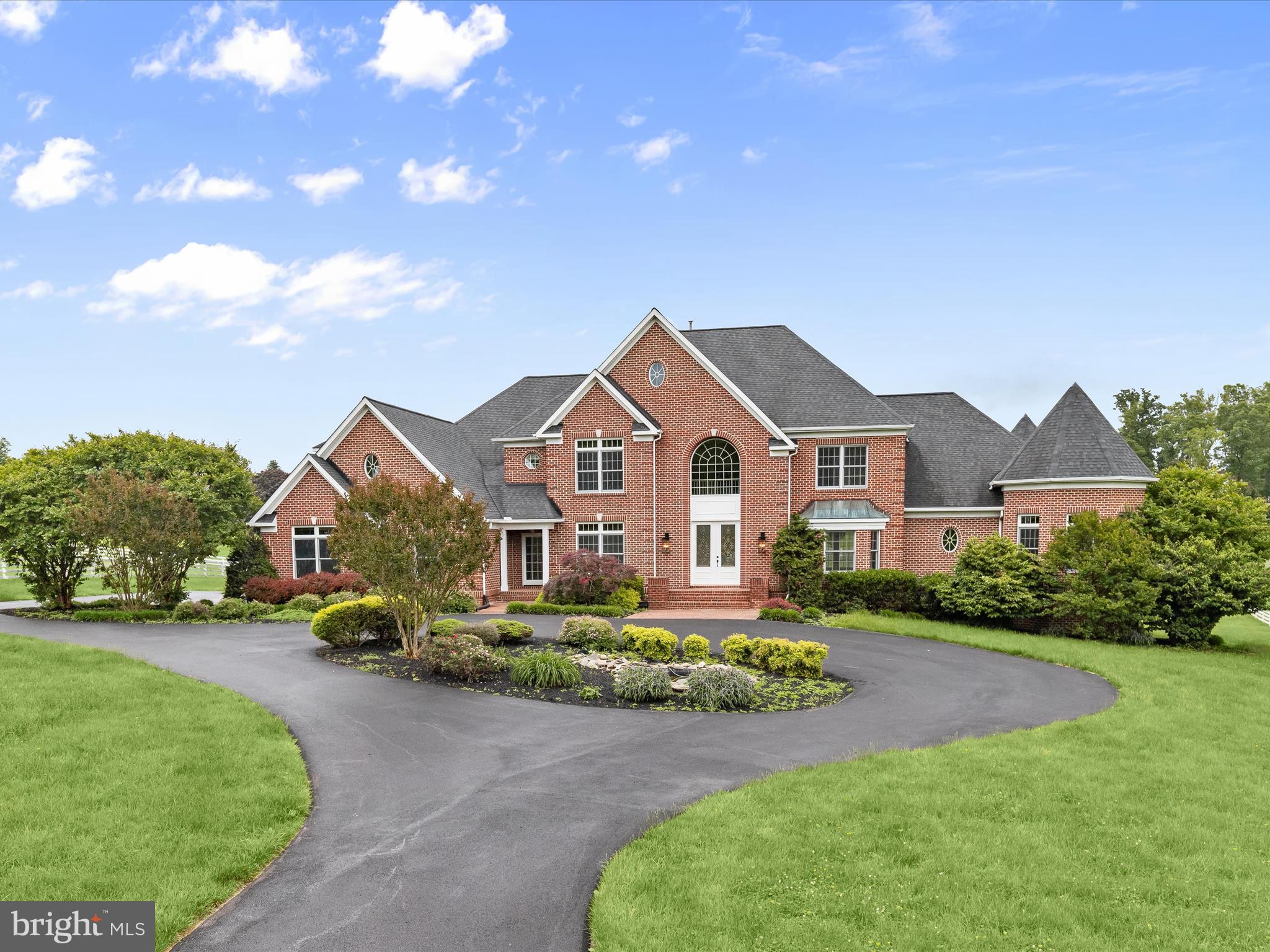 Nestled within the prestigious enclave of The Paddocks, this completely renovated and exquisite residence redefines luxury living. Spanning an impressive 10,000+ total square feet, this architectural masterpiece, constructed in 2000 with enduring brick elegance, offers a harmonious blend of sophistication and comfort. Step inside to discover a grand foyer that sets the tone. Gleaming hardwood floors leads you to all areas of the home . The home office is secluded to the left but go across the entry to the beautifully painted living room and dining room rich with crown moldings and hardwood floors. The gourmet kitchen is a culinary enthusiast's dream, equipped with top-of-the-line appliances, new quartz top island, new white cabinetry, new floors and ample space for culinary creations, seamlessly flowing into elegant dining and living areas that invite gatherings and celebrations. Enjoy the tranquil views of the beautiful backyard from the eat in kitchen that opens to the family room bathed in natural light by the surrounding windows. The two-story family room ensures convenience but the stunning fireplaces throughout the home is perfect for cozy evenings and entertaining guests in style. A large rear deck for entertainment, cookouts, or just relaxing is just off the family room and eat-in kitchen. A main floor primary suite with its own 2nd level sitting room and a new bathroom, laundry room, and 3 car garage completes the first floor. Upstairs boasts 5 additional generous sized bedrooms, each with its own completely renovated bathroom. For additional living space, the fully finished basement provides just that. Set on a sprawling 3.14-acre lot, the outdoor space is a private oasis, ideal for serene relaxation or grand outdoor events. The attached three-car garage and generous circular driveway provide ample parking for guests, enhancing the ease of entertaining. This property is not just a home; it is a lifestyle, offering unparalleled luxury and exclusivity in a tranquil setting. Experience the epitome of refined living in The Paddocks, where every detail has been thoughtfully curated for the discerning homeowner. Great commuter location, close to major routes, shopping, restaurants, parks, schools, even a golf course across the way!