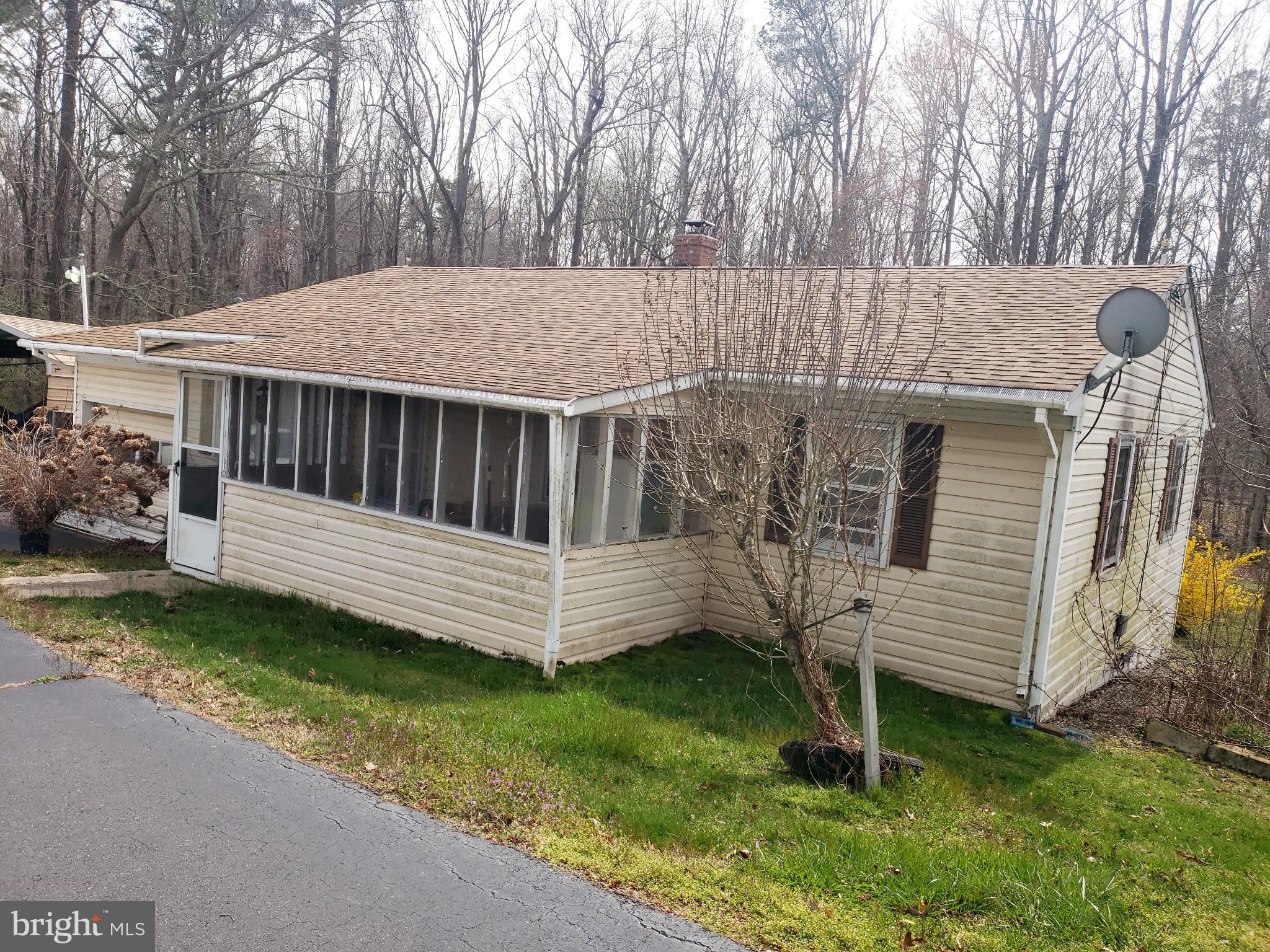 3BR / 1B Rambler on an acre of land w/garage (storage), Detached carport and outbuildings.  Paved driveway just off Hollywood/Leonardtown Road.    Hardwood floors throughout Living Room, Hall and bedrooms. Level rear yard bordered by trees.  Oil Furnace, water heater, utility sink and washer hook-up are located in the (walk-in) storage area under the home.