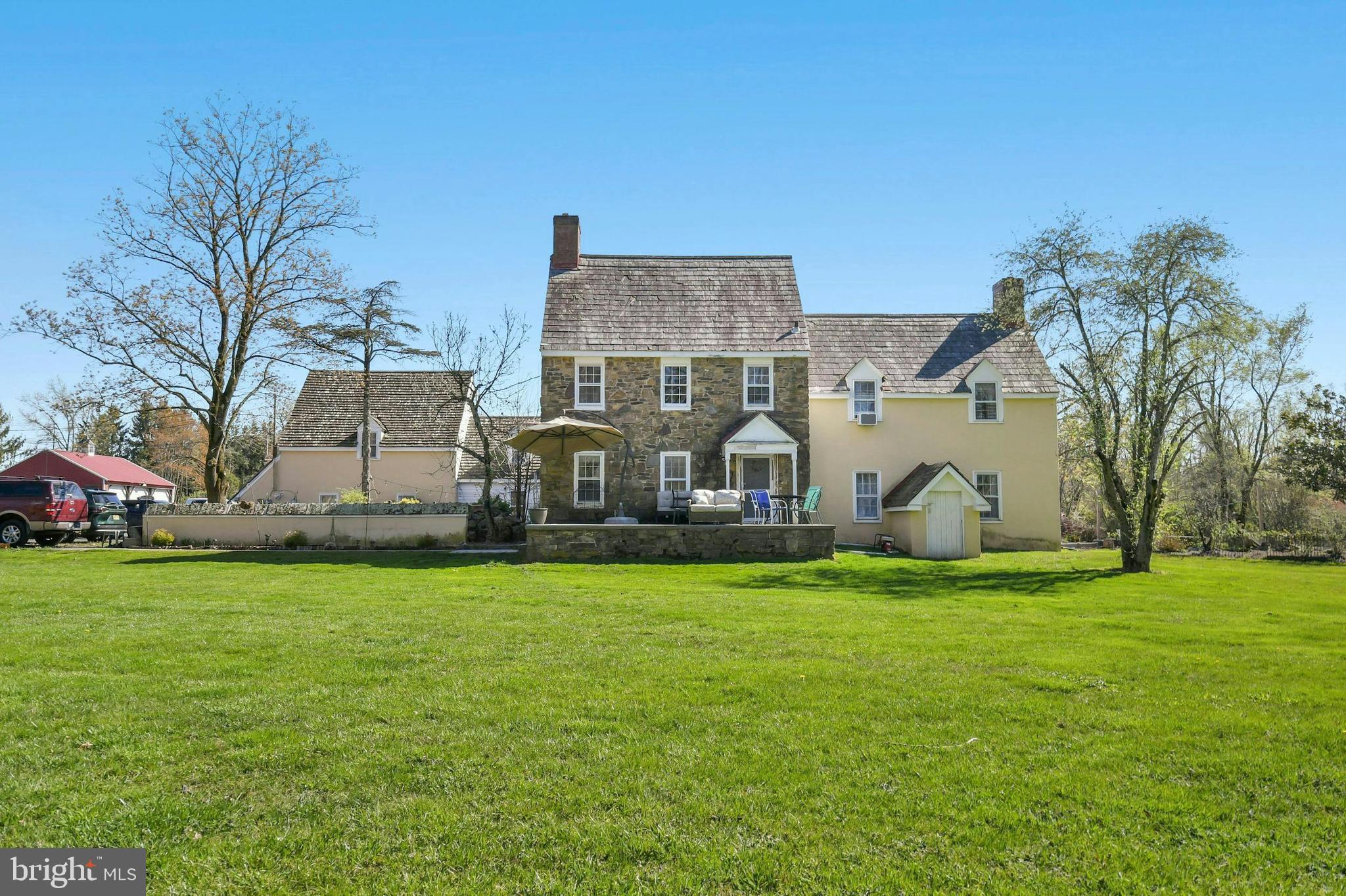 Opportunity awaits the savvy investor!  There are six, Township Permitted residential units and numerous outbuildings generating steady income with the potential to offer short-term rentals, home occupations, riding stables and horse boarding. Three tax parcels totaling nearly 13 acres are the backdrop for this charming country property.   The main house is a custom-built farmhouse teeming with character and charm.  Pine floors, hand-crafted cabinetry, deep windowsills, lovely built-ins and millwork, and a stone, walk-in fireplace contribute to the ambiance.  There are six bedrooms, three full baths, six fireplaces and main-level laundry.  Relax on the front porch or in the delightful courtyard with a pond.  Four more units surround the main home (three 1-bedroom units and one studio/pool house unit) each with separate entrances.  One of these apartments is ADA Compliant and enjoys outdoor space with a waterfall and koi pond.   There is a carriage house that contains a three-bedroom apartment with wood floors.  Below is an oversized garage with two bays and rear, covered storage.   Additional outbuildings include a 3-bay oversized garage, a 100 x 40 foot pool barn divided into two sections.  One section has a concrete floor, heat, a/c, and a powder room.  There are more storage structures and parking is plentiful.   Most of the infrastructure is on one parcel.  There may be development opportunities in addition to the current income producing configuration.  There is potential for a significant increase in the current $9000 monthly income.  Come see all that this property has to offer.