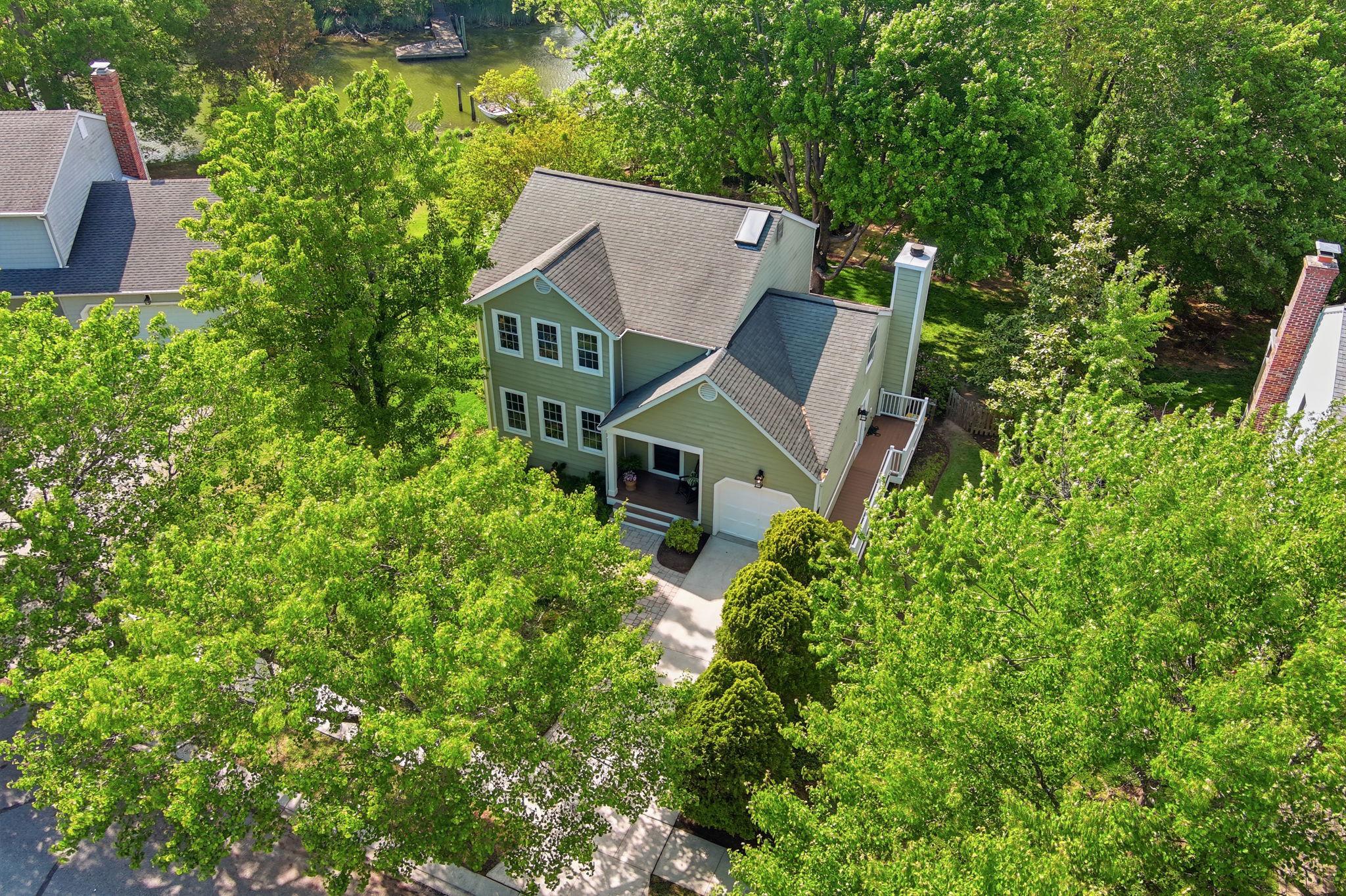 Annapolis Waterfront home located right off the South River with easy access to the Chesapeake Bay. This recently updated home offers the perfect blend of luxury, comfort, and waterfront living.  Inside, you’re welcomed by refinished hardwood floors and abundant natural light. The updated kitchen features new GE stainless steel appliances and opens to a cozy living room with a wood-burning fireplace and direct access to the deck; ideal for dining under the stars overlooking the peaceful backyard and creek. A main-level laundry/mudroom with side entrance and ramp adds everyday convenience.The primary suite is a true retreat, featuring a waterfront-facing design with a private balcony and updated en-suite bath. Three additional bedrooms with new carpet offer flexibility for guests, a home office, or growing needs. The fully finished walkout lower level provides a private in-law suite with its own entrance, full kitchen, large updated bath, and laundry hookup; perfect for extended stays or entertaining. Outside, enjoy 50 feet of waterfront with a private dock, kayak rack, and a spacious .41-acre lot offering plenty of room to relax, garden, or play. Ideally located with easy access to Historic Annapolis and Naval Academy, BWI, and DC, this home offers the best of peaceful waterfront living in Annapolis and everyday convenience.