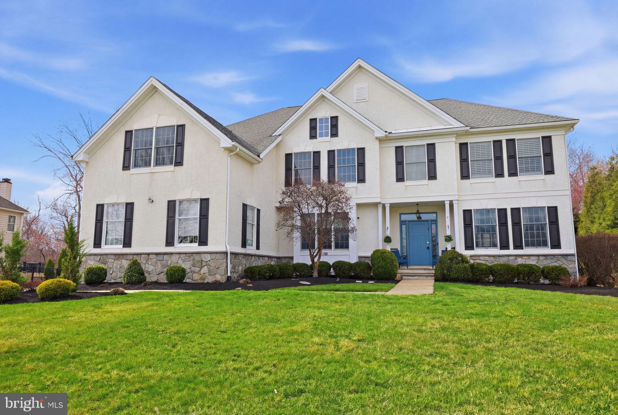 Welcome to this stunning Traditional Center Hall Colonial located in the highly sought-after Penn Preserve neighborhood of Newtown, offering exceptional curb appeal and an ideal blend of elegance, comfort, and functionality. This beautifully maintained 5-bedroom, 3 full and 2 half bath home welcomes you with a front-to-back foyer, highlighted by an elegant staircase, a front door with full-length sidelights and a transom window, and rich hardwood flooring that flows throughout much of the home.
The foyer is perfectly flanked by a formal dining room on one side, featuring custom moldings, hardwood floors, and a charming window bench, and a spacious living room on the other, complete with decorative ceiling molding and recessed lighting. Double French doors lead from the living room into a private first-floor study—ideal for working from home.
At the heart of the home is the gracious, light-filled kitchen, offering premium stainless steel appliances, quartz countertops, a center island, tiled backsplash, recessed lighting, and hardwood floors. A sun-drenched breakfast room with a cathedral ceiling overlooks the private, wooded backyard, creating a perfect everyday gathering space. The kitchen opens seamlessly to a dramatic two-story great room featuring a gas fireplace, hardwood floors, and a rear staircase to the second level—an inviting space for relaxing or entertaining.
Upstairs, you’ll find five generously sized bedrooms, including an opulent primary suite with a tray ceiling and an exceptional walk-in closet. The recently renovated primary bath boasts dual quartz vanities, a soaking tub, a separate shower, and elegant ceramic tile finishes. One secondary bedroom features its own private bath, while three additional bedrooms share a well-appointed hall bath. A convenient second-floor laundry room adds to the home’s thoughtful design.
The large finished basement provides the perfect space for recreation, a home gym, or media area, along with ample storage.
Step outside to your own private oasis, complete with a maintenance-free deck, an expansive paver patio with slate stone inlays, beautifully crafted stone walls with bluestone caps, and a fire pit—perfect for entertaining or relaxing under the stars. A garden area and irrigation system enhance the outdoor space, all set against a serene wooded backdrop.
Additional highlights include a 3-car garage and a prime location close to downtown Newtown, restaurants, shopping, and local wineries. Situated within the award-winning Council Rock School District, with easy access to New Jersey, the Route 1 Princeton Corridor, I-95, and train lines to New York City, this exceptional home truly has it all.