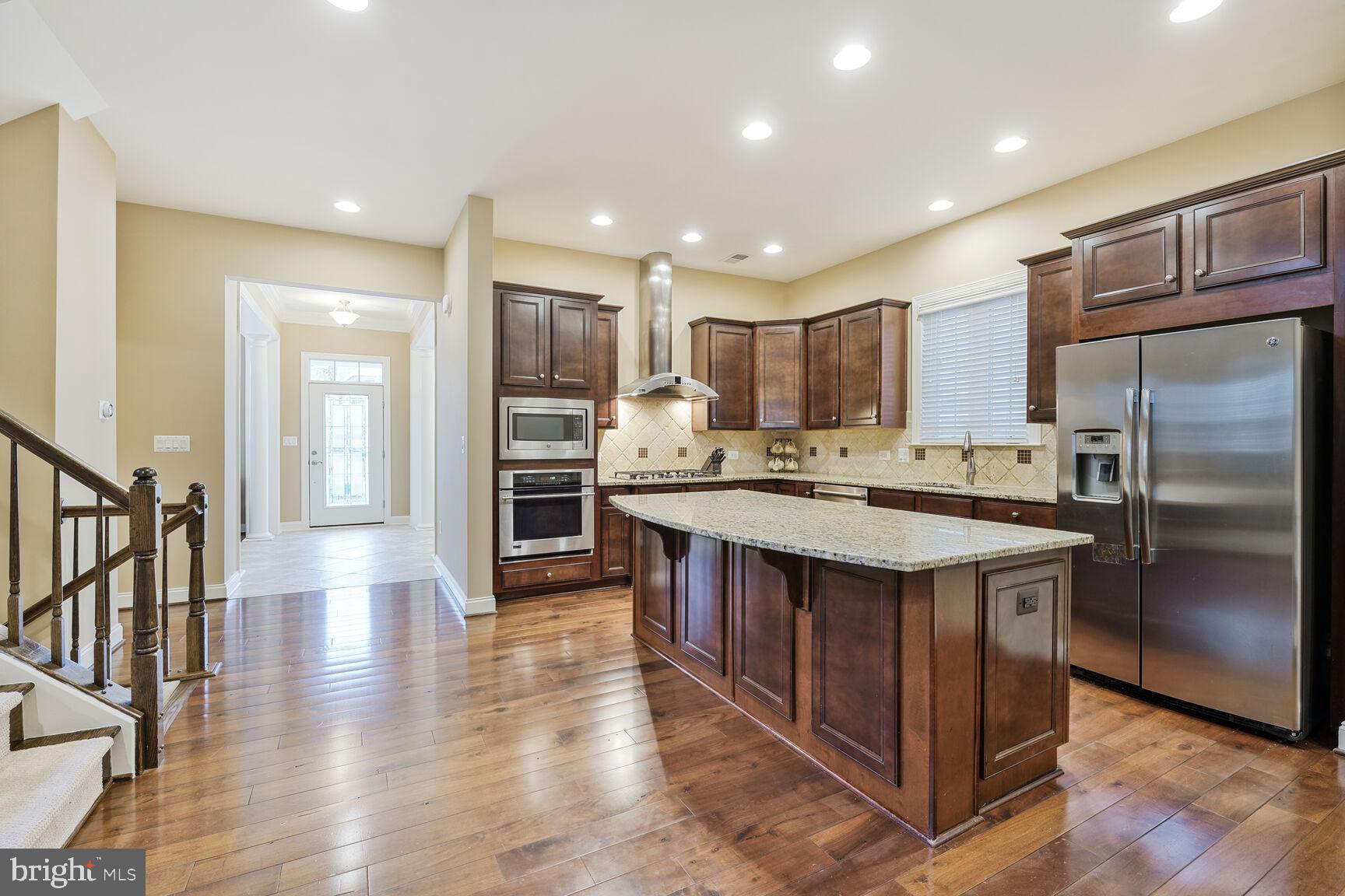 Prepare to be wowed as you step inside this impressive stone-front 4-bedroom, 4.5-bathroom home in the sought-after Northampton neighborhood of Kingstowne! You’ll enjoy so many beautiful architectural details throughout the almost 4,000 sq.ft of this lovely home.  On the main level, there are wood floors and 10’ ceilings, with formal dining and living rooms in front and family room and kitchen in the back.  Cooks will love the gourmet kitchen with its expansive island, 5-burner gas cooktop, professional-grade hood, and convection wall oven with built-in microwave.  In addition, there are plenty of cabinets and a pantry for storage.   On the upper lever are four spacious bedrooms and three bathrooms.  The oversize primary suite features TWO large walk-in closets, and a spa-like bathroom with double vanities and jetted tub.  One of the secondary bedrooms is an ensuite, with the other two bedrooms sharing a large hall bathroom.  There is new carpet throughout this level.  The finished lower level features a large rec room (with door to walk-up stairs), two additional rooms perfect for use as an office or exercise room, and a separate storage room.  In addition to the wonderful features of this home, living in Kingstowne provides access to community amenities including multiple swimming pools, fitness centers, tennis courts, playgrounds, walking/jogging paths.  Kingstowne Town Center shops, restaurants, and cinema are very close by.  There is easy access to two metro stations, I-95/I-495, FFX County Parkway, Mark Center, and Fort Belvoir.