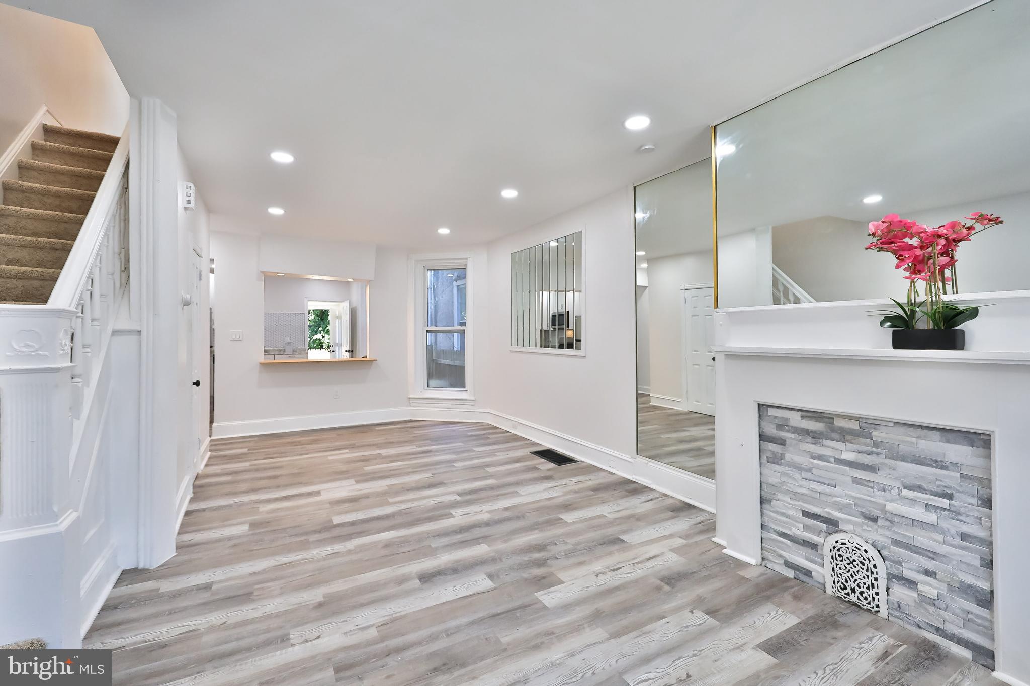 Sharp and stylish, this brand-new renovation of a fantastic brick End of Row-Townhouse in dynamic West Oak Lane- is now 'picture perfect ready' for its next fortunate Homeowner. Charmingly positioned on a quiet One-Way street, where a well-tended green space next door extends gracefully to its elevated wrought iron gated, freshly painted Porch. A nearby lovely shade tree arches elegantly over a friendly welcome, where parking is a-plenty just right out front. A stately new white steel Entrance Door with Ring Doorbell announces company, then opens to reveal a spacious Modern take on a 3BR, 1.5 B Philadelphia Classic! Designer features rein throughout. Fun Mirrored walls expand the open-concept living spaces with natural light dancing about the spectacular high-functioning flooring in stunning shades of warm greys, whites, and pewters. A charming original Mantle serves as a lovely focal point, as well as the beckoning Breakfast Bar announcing the inviting new Kitchen beyond. Stainless appliances and gas stove cooking are framed by gorgeous wall tiles. An adjacent Laundry/ Pantry/ Mud Room allows for an effortless indoor/ outdoor experience. The just-completed (October 2023) upgraded fenced-in Rear Yard, now invites pets, plus small and big kids alike- to frolic away in serene privacy. On the Lower Level, a handsome finished space awaits for expansive gatherings/ living needs, with a new Powder Room to serve. Plush new carpeting underfoot comforts as one ascends the staircase to the Upper Level. Peacefully knowing that all interior heating, wiring, plumbing, and window systems have been upgraded for maximum safety and efficiency is a bonus, indeed. Upstairs, find a large and sparkling Full Bath where house-beautiful designer tiling heightens the experience for the surrounding three lovely light-filled Bedrooms-  all ready for glorious use as desired. Quick Closing available to best enjoy the Seasonal festivities ahead in your !