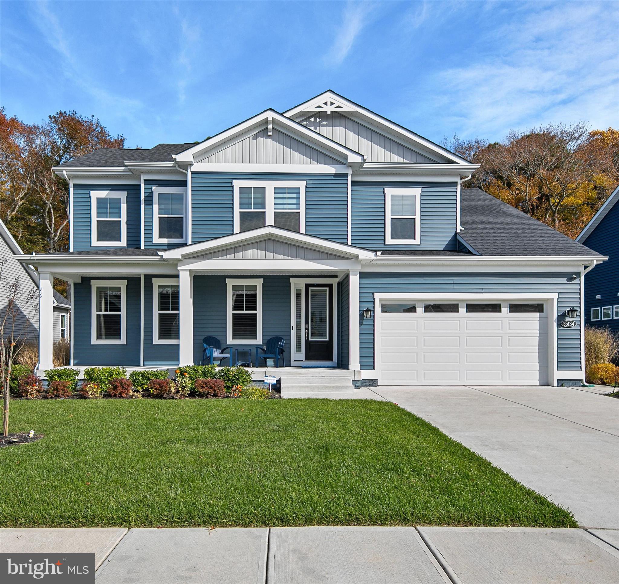 A SHOWCASE OF COASTAL RESORT LIVING in THE ESTUARY, an upscale community offering a wealth of amenities including social hub Clubhouse, fitness center, pool with huge patio surround, tennis/pickleball/bocce courts, miles of walking trails, and PRIME LOCATION BETWEEN BETHANY BEACH & FENWICK! A beautifully maintained and tastefully furnished home in the prestigious community of The Estuary in Frankford, Delaware. This two-year-old residence is situated on a premium lot with a tree-lined backyard and generous space between neighbors, the setting provides a sense of privacy and tranquility that’s hard to find.  Inside, thoughtful design upgrades and custom touches elevate every room. Ship lap accent walls add warmth and coastal charm in the office, powder room, front hallway, primary bathroom, loft, upstairs hallways, and bedrooms. The stairway has been enhanced with elegant wrought iron balusters. Throughout the home, Silhouette blinds filter the light beautifully while offering privacy, and builder-grade mirrors have been replaced with upgraded framed designs for a polished, refined look.  The kitchen is a showpiece, designed for both everyday living and entertaining. It features double wall ovens, a five-burner gas cooktop, and white trimmed, soft-close cabinetry topped with elegant crown molding. The expansive island comfortably seats six, perfect for casual meals or gathering with friends. A classic glass subway tile backsplash and pantry for storage complete this bright and functional culinary space.  The adjacent dining area provides easy access to the screened porch with a gas burning fireplace.    The living room is a true centerpiece, reimagined with a custom electric fireplace surrounded by white quartz stone veneer, floating tempered glass shelves with glass-tile backing, and built-in cabinetry topped with underlit quartz countertops that match the kitchen for a cohesive design flow. A custom driftwood mantel completes this inviting space.  Retreat to the primary suite, where a tray ceiling adds architectural interest and the generous walk-in closet where the primary closet now features tile flooring that seamlessly matches the adjoining bathroom. The spa-inspired bathroom offers a dual sink vanity, private water closet, and a frameless glass shower featuring dual shower heads and bench seating, all complemented by tile finishes and thoughtful design details.  The laundry room offers practical luxury with added cabinets, quartz countertops, an upgraded sink and faucet, and open shelving. The garage has been completely transformed with custom cabinetry, an epoxy-coated floor, fresh paint, and a convenient built-in bench with storage.  Ascend to the upper level, where an inviting family room awaits, accompanied by three additional bedrooms. One features a private ensuite bath, while a full hall bath serves the remaining rooms, ensuring comfort and privacy for both family members and guests.  Additional thoughtful details include custom mango wood cabinets in all bathrooms, upgraded fans in every room and the screened porch, enhanced irrigation with smart sensors, and dimmer switches throughout for tailored lighting control.  This sought-after coastal community offers a true resort-style living experience surrounded by natural beauty and abundant recreation. Residents enjoy an outdoor pool with sun deck, clubhouse with fitness center and billiards, and welcoming gathering spaces. Active living thrives with tennis and pickleball courts, walking and jogging trails, bocce, a putting green, and a dog park with separate areas for small and large dogs. A fishing pond across the street is stocked with big bass, and the HOA provides lawn care, snow removal, and a seasonal beach shuttle. Nearby, the Assawoman Wildlife Area offers boat launches, hiking, biking, and wildlife observation. Blending resort amenities with preserved landscapes, The Estuary delivers a rare balance of relaxation, recreation, and connection to nature.