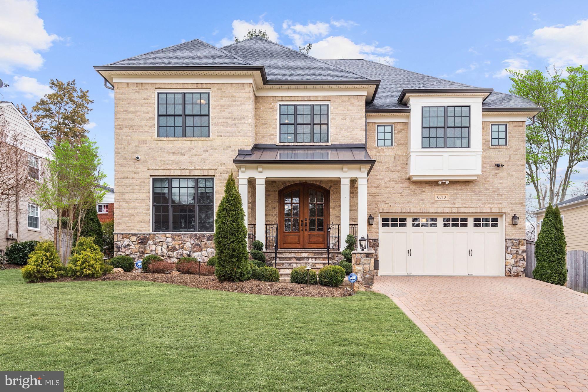 Handsome all brick and stone colonial just blocks from the center of McLean for coffee shops, restaurants and shopping. The house was built with attention to detail and decorator appointments throughout.  The open floor plan has great flow for entertaining.  High end finishes include the wainscoting and rich mouldings throughout all the rooms on the main level, five inch Brazilian Cherry flooring on the main and upper levels and beautiful stone used on every level.  A great bonus is that the study can be a main level bedroom since it has an attached full bath and a walk-in closet.  The chef's kitchen includes: stainless steel Thermador appliances and professional stove, huge center island with marble countertop and Marvel beverage refrigerator, an oversized pantry and an office cubby with a desk and cabinets. Adjoining the kitchen is the family room with coffered ceiling, stone gas fireplace and walls of windows.  Atrium doors take you to the flagstone terrace with great views of the professionally landscaped and totally fenced backyard.  The spacious mudroom has a slate floor, built-in bench and coat closet.  The master suite includes a tray ceiling, sitting room, his and her closet with separate entrances and a luxury marble master bath with his and her vanities, large Kohler whirlpool tub and three sided glass shower. The laundry room is very attractive with a stone floor and wall of cabinets with granite countertop.  The three additional bedrooms are very spacious and they all have walk-in closets. The walkout lower level has a doggie door, huge rec room, den/sixth bedroom, a media room and a custom Cherry wood bar with sink & refreshment refrigerator.   The garage is nicely finished with a painted floor and a Gladiator system with a workbench, cabinets and wall mounts.  Other amenities include Wi-Fi thermostats, A/V system throughout house to include built in speakers on all three floors and cameras, a handsome paver driveway, lawn sprinkler system and  a backup Generec generator. The location is ideal for commuting to DC, two international airports, Tysons and Dulles Business Centers.  Just five minutes to East Falls Church Metro or the Silver Line Metro.