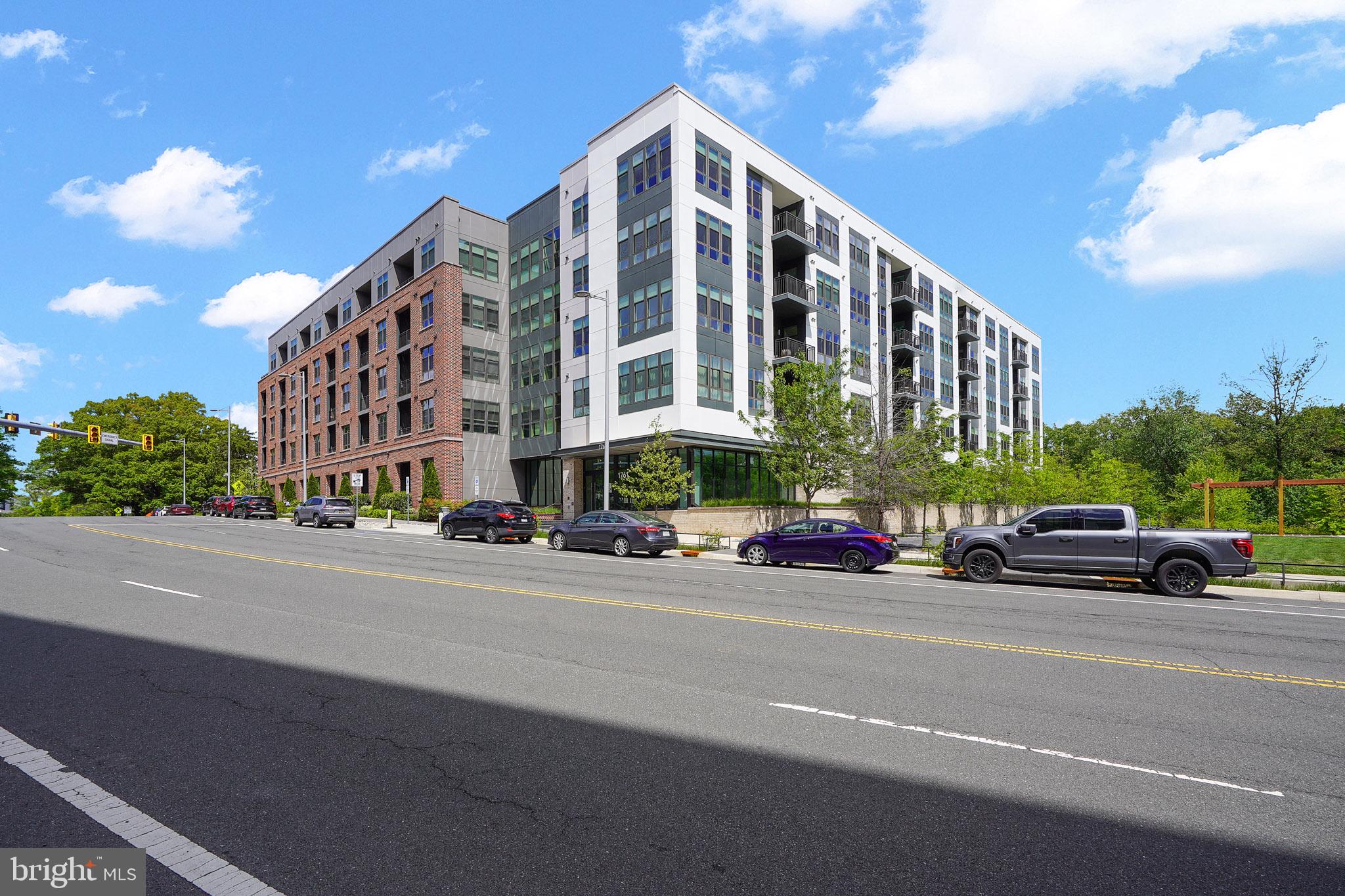 Welcome to The Bexley, Tysons' premier luxury condominium community, where sophisticated design meets effortless everyday living. This beautifully appointed residence offers an open-concept layout with soaring 10-foot ceilings, wide-plank LVP floors, and expansive windows that flood the home with natural light. The chef's kitchen is appointed with quartz countertops, a large center island, modern cabinetry, and premium stainless-steel appliances — ideal for both casual mornings and elevated entertaining. The spacious primary suite offers a private retreat with an over-sized shower and generous walk-in closet with built-in cabenitry, while the additional bedroom provides flexibility for guests, or a media room.  The den functions as an office or guest room.  Step outside onto your private balcony and enjoy the serene, tree-lined backdrop that makes this home feel like a world apart — yet you're under a mile to the McLean Metro and minutes from Tysons Galleria, Capital One Hall, Whole Foods, and an abundance of dining and shopping. Two garage parking spaces convey along with a storage unit. Residents of The Bexley enjoy upscale amenities including a modern fitness center, resident lounge, concierge service, outdoor grill area and pet-friendly spaces. This is refined, low-maintenance living at its finest.  Seeing is believing!