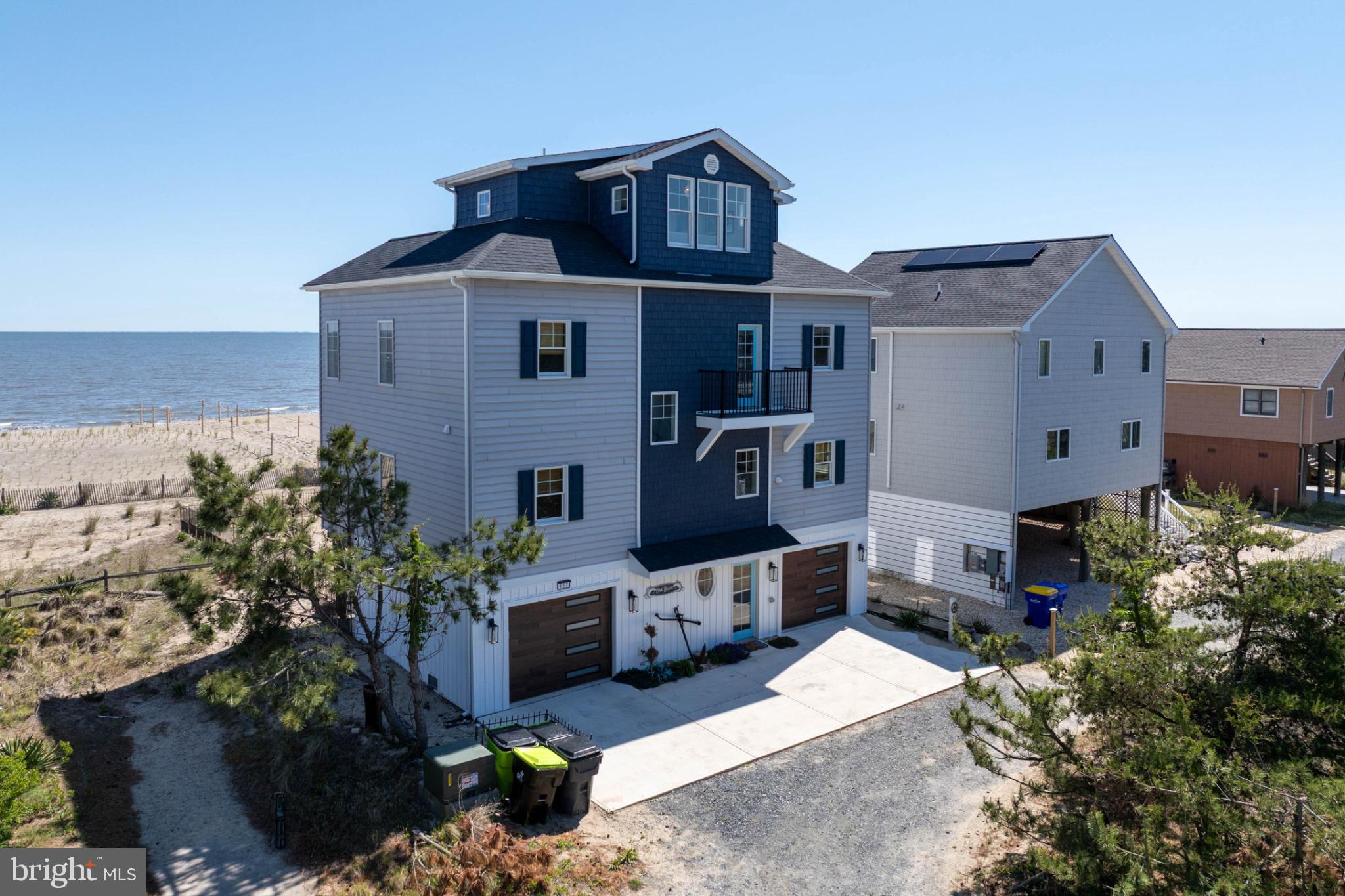 Nearly New Construction Without the Wait on Broadkill Beach!
Built in 2024 along the gentle shores of the Delaware Bay, this stunning home features a bright, open floor plan with sweeping views stretching from Lewes to Cape May. Step inside to discover a thoughtfully designed interior that perfectly balances elegance and warmth. The homeowner is a small custom home builder who originally built the home for personal use, culminating in attention to detail.
The reverse floor plan maximizes the breathtaking water views from the Andersen windows, offering main-level bedrooms and a second level that includes a gourmet kitchen with stainless steel appliances, along with spacious dining and living areas. A widow’s peak third floor with a wet bar and beverage station provides the perfect setting for entertaining or watching the sunrise over the bay.
Boasting 2,600 square feet, 3 bedrooms, and 4 full baths with custom work, this property offers ample space for family and friends to spread out, while also serving as an attractive beach rental opportunity.
The lower level features a 2-car garage, Tesla charger, two outdoor showers, and a fenced yard complete with games and a fire pit. Rental revenue exceeded $110,000 in 2025 and is on track to achieve similar income in 2026.
Offered furnished, with minor exclusions, this turnkey property is ready for your summer adventures.
Welcome Home!!