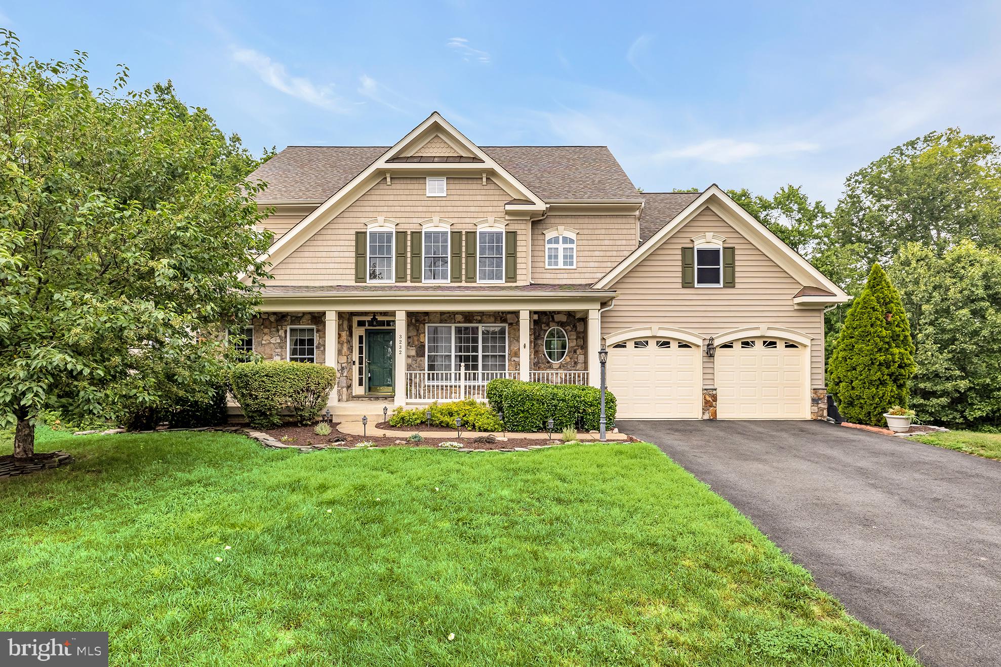 Set on a half-acre corner lot with beautiful seasonal water views, this expansive 6-bedroom, 4.5-bath home in Stonewall Manor offers approximately 6,300 square feet of thoughtfully designed living space. A gracious foyer opens to formal living and dining rooms, while the heart of the home features a bright two-story family room with floor-to-ceiling windows, coffered ceilings, and a gas fireplace.

The open main level flows seamlessly into a spacious chef’s kitchen with granite countertops, gas cooking, generous cabinetry, and a large center island with bar seating. A private home office, powder room, and access to the rear deck complete the main level.

Upstairs, the spacious primary suite includes an oversized walk-in closet with custom built-ins and a spa-like bath with a soaking tub and separate shower. Three additional upper-level bedrooms include an en-suite guest room and two bedrooms connected by a shared full bath.

The finished lower level offers impressive flexibility with two legal bedrooms, a full bath, wet bar with wine refrigerator, movie theater, game area, gym, sauna, storage, and a separate entrance. Outdoor spaces include a deck, stone patio, river rock landscaping, and a Japanese maple.

Additional highlights include a two-car garage with workbench, overhead storage, and 220V/50-amp EV charger, plus three-zone heating and cooling. Ideally located minutes from I-95, VRE, shopping, dining, and Quantico.