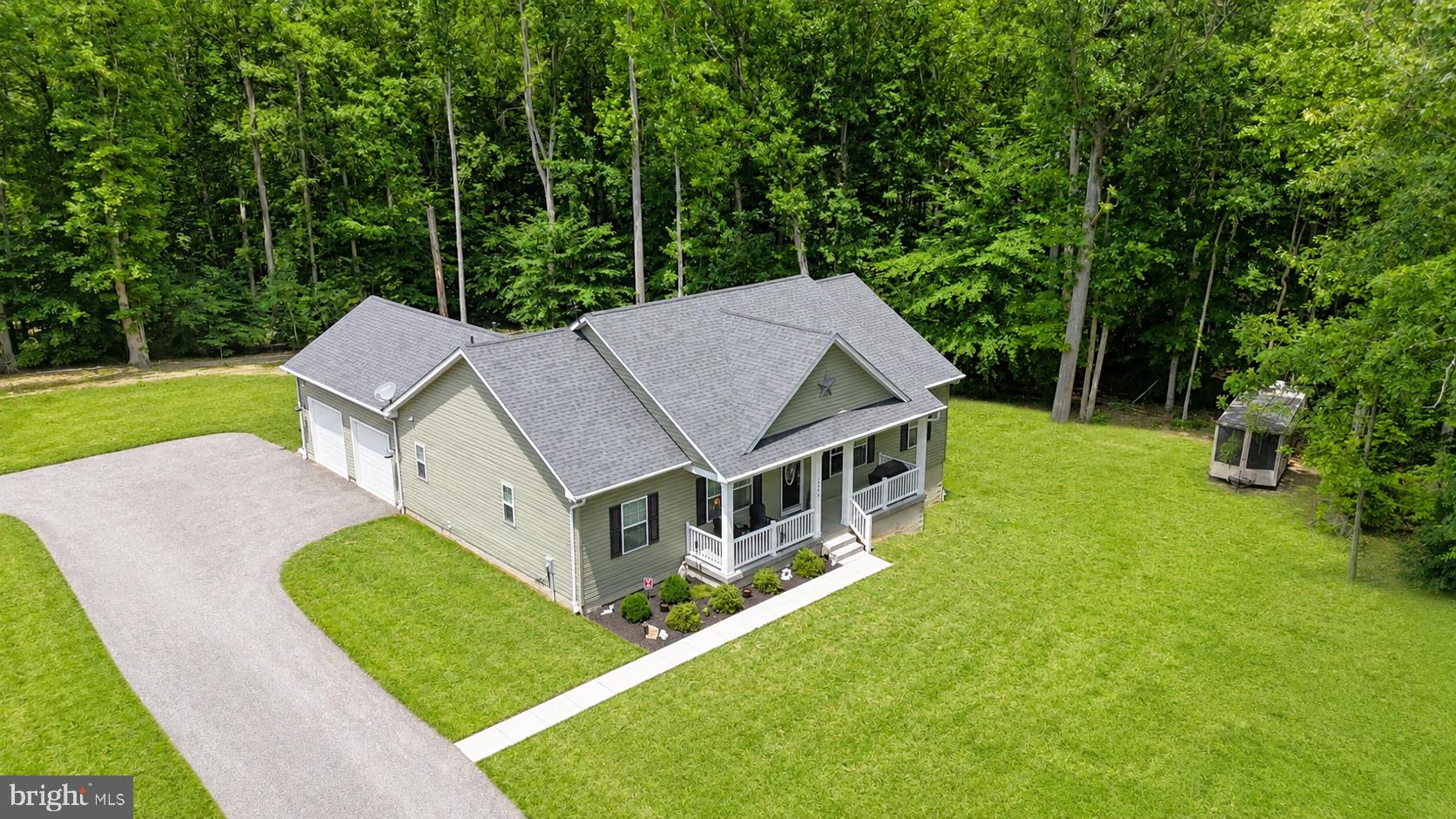 Tucked away on 3 private wooded acres in the heart of Prince Frederick, this custom-built rambler by Southern Maryland Development offers the perfect blend of quality craftsmanship, modern comfort, and peaceful country living. Built just four years ago, this home was thoughtfully designed for buyers who value privacy, space, and the convenience of one-level living. No HOA.

A welcoming front porch sets the tone, inviting you to slow down and enjoy the quiet surroundings. Inside, you'll find upscale finishes throughout, including high-end granite countertops, custom Levolor blinds, and a beautifully designed owner's suite featuring a floor-to-ceiling tiled shower, custom glass shower door, and tiled bath floors. The second full bath is equally well-appointed with tile flooring and quality finishes.

The spacious kitchen serves as the heart of the home, offering abundant workspace, premium granite surfaces, a large island, and an open layout ideal for everyday living and entertaining. Modern systems provide peace of mind, including an owned water filtration, chlorination, and water softener system.

Surrounded by mature trees and set well off the road, this property offers the privacy and tranquility that are becoming increasingly difficult to find. Whether you're looking for room to spread out, space for hobbies, a place to enjoy nature, or simply a newer custom home without the restrictions of a neighborhood HOA, this property delivers.

Private. Custom built. Move-in ready. A rare opportunity to own a quality home on three beautiful acres in Calvert County.
