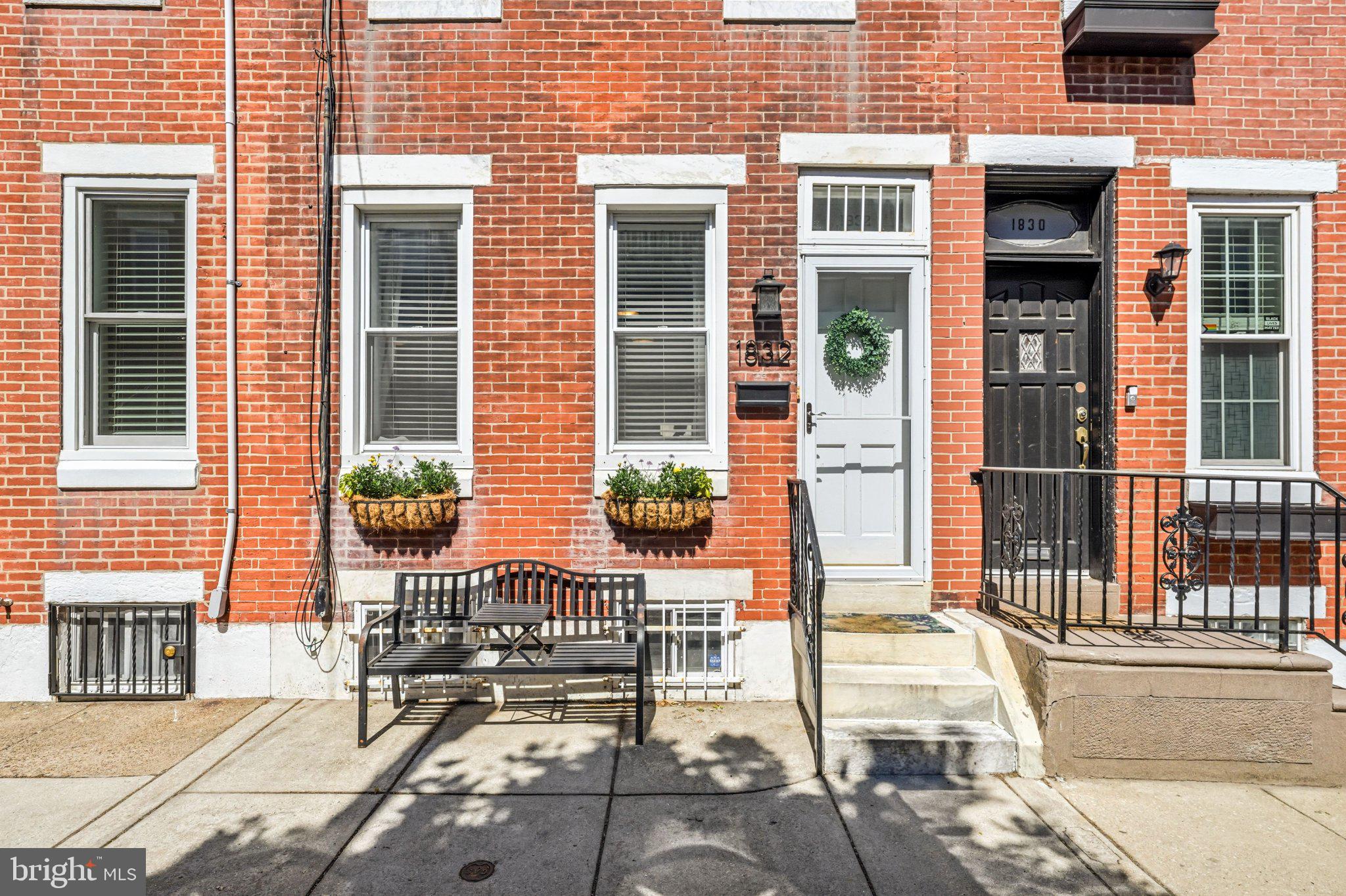 Tucked away on an exceptionally peaceful, low-traffic block, 1832 S Sartain Street offers a serene escape that feels worlds away from the city’s hustle and bustle. This meticulously maintained home welcomes you with a handsome brick facade and an interior that is bright, airy, and full of classic South Philly character.

Step inside to an open-concept main floor where high ceilings and crisp finishes create a sense of space that’s hard to find in the city. The living and dining areas flow seamlessly into a stylish kitchen, complete with contemporary cabinetry, exposed brick wall, stainless steel appliances, and plenty of prep space for your next culinary adventure. Just beyond the kitchen, a private rear patio provides a secluded outdoor retreat. A perfect place for quiet morning coffee, evening grilling, or tending to a container garden.

Upstairs, the home features three comfortable bedrooms with ample closet storage and a sleek, updated primary bathroom. The basement offers additional versatility, providing plenty of room for storage, a home gym, or a dedicated laundry area.

While the street itself feels like a calm, hidden gem, the location puts you right in the heart of one of Philadelphia’s most vibrant scenes. You are just a couple of blocks from the legendary flavors of East Passyunk Avenue, where you can spend your weekends exploring eclectic boutiques, world-class dining, and cozy coffee shops. With easy access to public transit and major highways, the rest of the city is right at your fingertips. This home offers the best of both worlds: a tranquil home base and a front-row seat to the best lifestyle South Philadelphia has to offer.