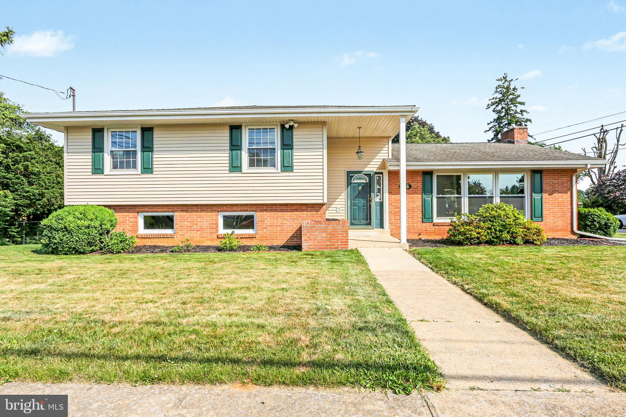 Welcome to this sprawling split-level home in the desirable Manor Section of New Cumberland, offering bright, spacious interiors, a functional floor plan, and exceptional spaces for everyday living and entertaining. The inviting Living Room features a large triple window and engineered hardwood flooring that continues into the formal Dining Room, creating a wonderful flow on the main level. The eat-in kitchen offers abundant counter space, desk seating, and includes refrigerator, dishwasher, oven/range, and built-in microwave, with convenient access to the carport and rear patio for easy indoor-outdoor living. Upstairs, you'll find four generously sized bedrooms, three with beautiful hardwood floors with a hall bath featuring wainscoting and a tub/shower combination. The primary suite boasts brand-new carpeting and a private full bath with wainscoting and a walk-in shower. Gather with guests in the family room with ceramic tile flooring and classic wood paneling or enjoy additional living space in the lower-level recreation room complete with a wood-burning fireplace and adjacent full bath with walk-in shower. Storage is plentiful in the mechanical room, convenient designated laundry room, oversized one-car garage, and storage shed. Additional highlights include fresh, neutral paint, replacement windows throughout, architectural shingle roof, gas hot-water baseboard heat, central air, radon mitigation system, and ample off-street parking between the driveway, carport, and garage. Ideally located with easy interstate access and just minutes from New Cumberland's vibrant downtown, restaurants, shops, and community amenities. Move-in ready and waiting for its next owner—schedule your showing today!